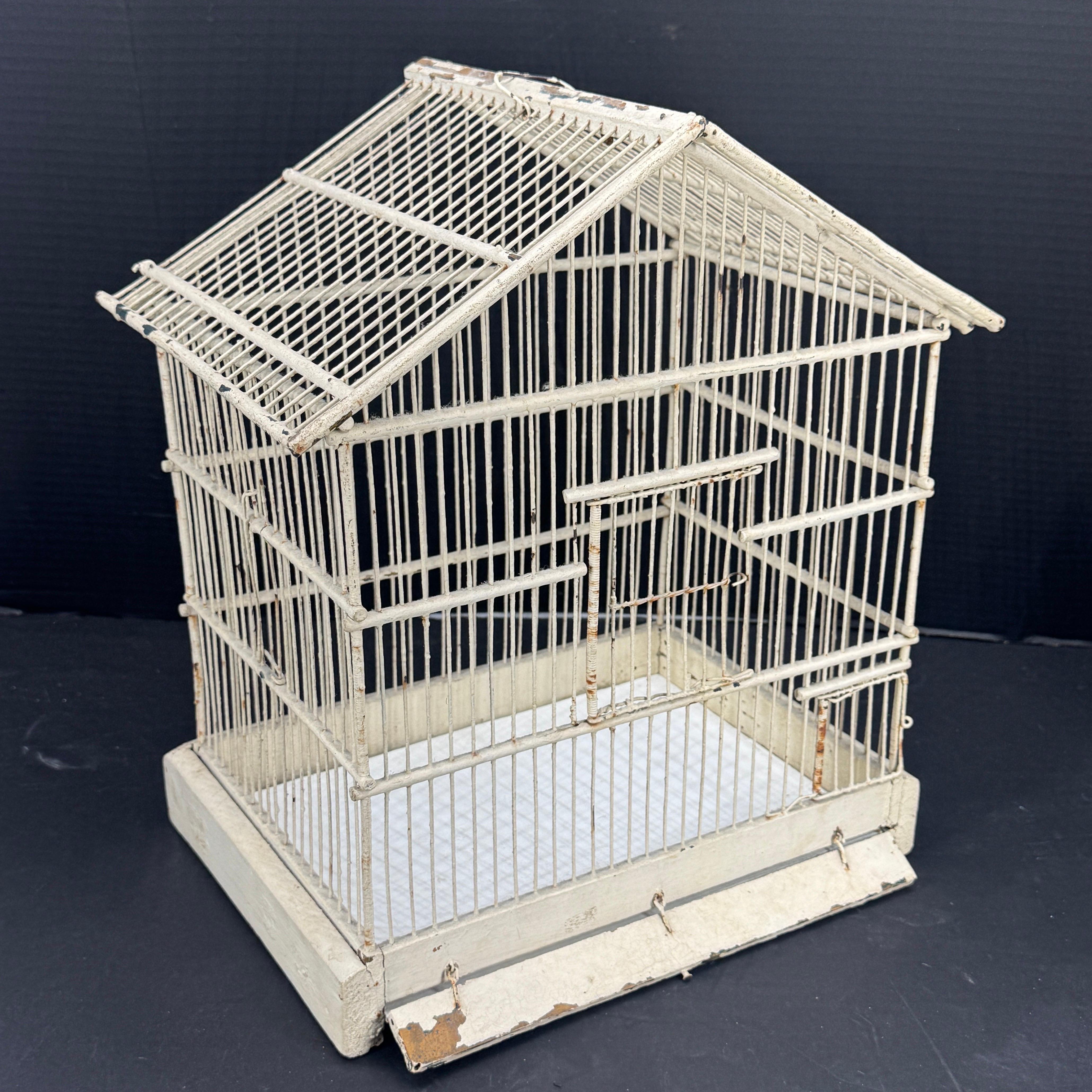 As found in a market in South France, a pretty French birdcage from the 1950s with a warm cream neutral paint finish. The cage is made from metal and wood. Wonderful patina on this classic piece. A wonderfully decorative accent for both modern and