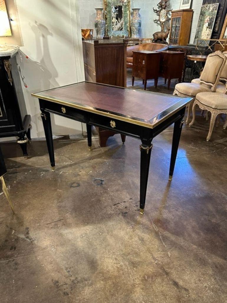 Vintage French Jansen Manner black lacquered Louis XVI style writing desk. Circa 1940. A timeless and classic touch for a fine interior.