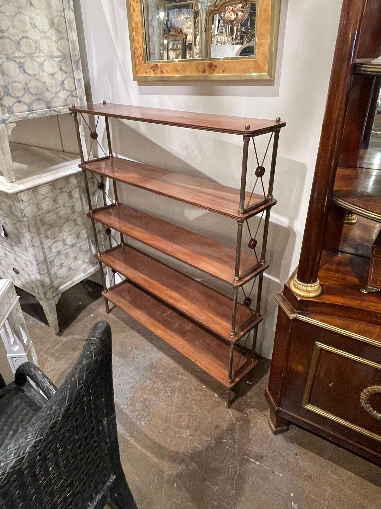 Beautiful vintage French Jansen style mahogany and brass narrow etagere. A great transitional piece that mixes well with a variety of decors.