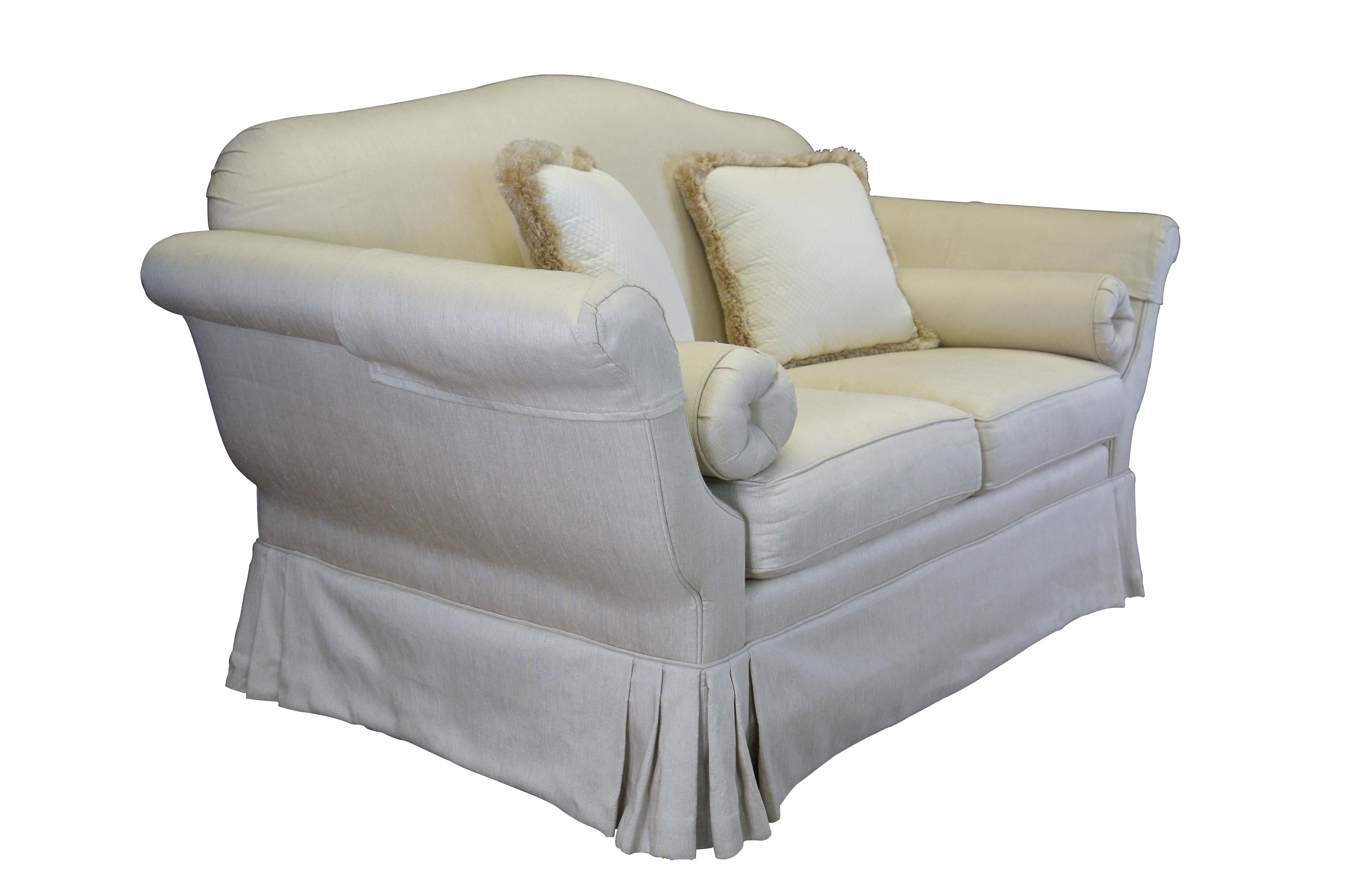 Vintage silk down filled loveseat / settee / sofa or couch featuring a formal tapered chaise lounge design with high rolled arms and arched back over skirted base.  Includes bolster and lumbar pillows.  Off white / beige. Knole inspired French