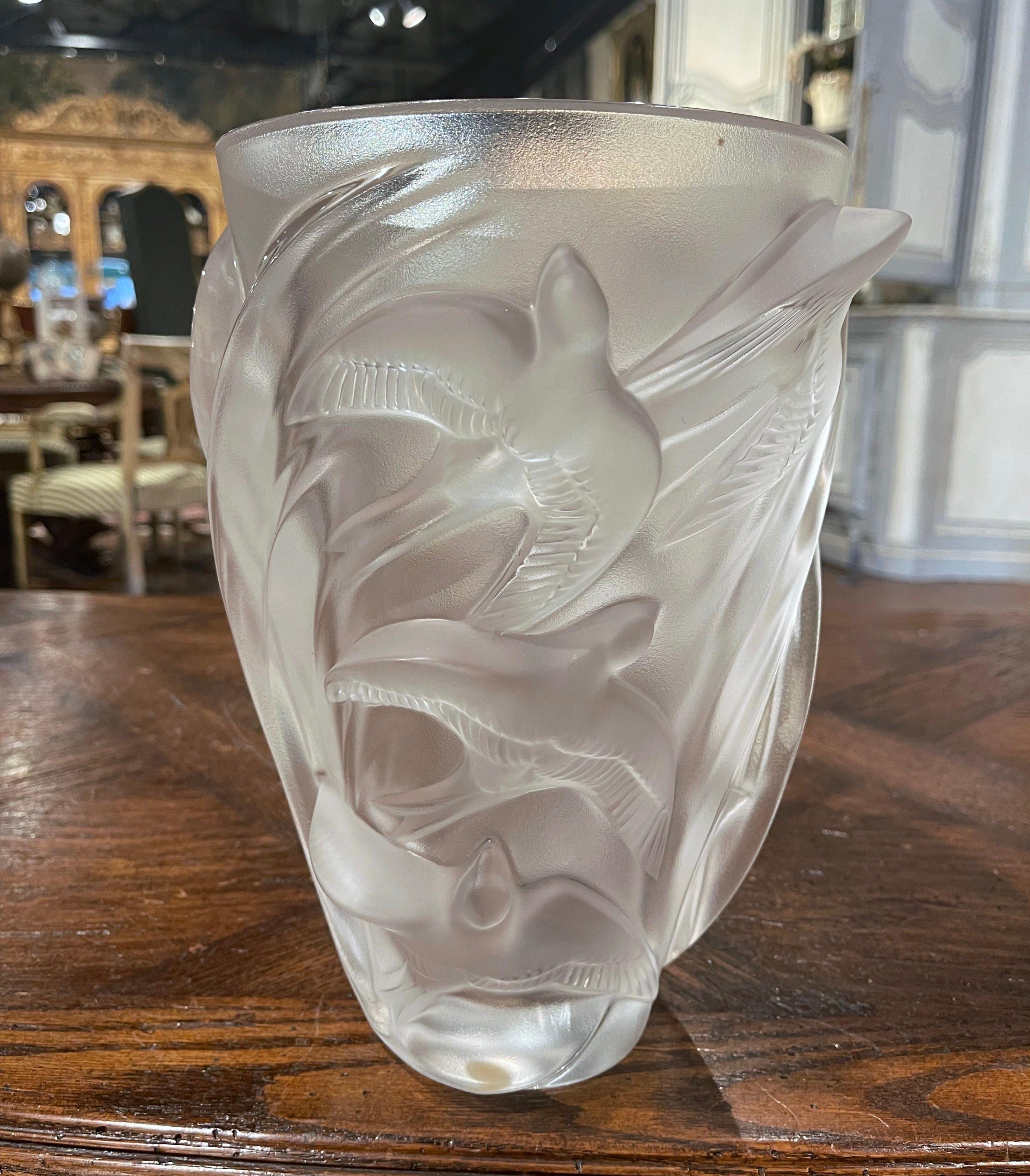 Decorate a table or console with this elegant vintage vase. Hand crafted by Lalique in France circa 1980, this elegant Lalique crystal vessel is circular in shape, and captures the symbolism of this graceful bird, the dove with represents fidelity