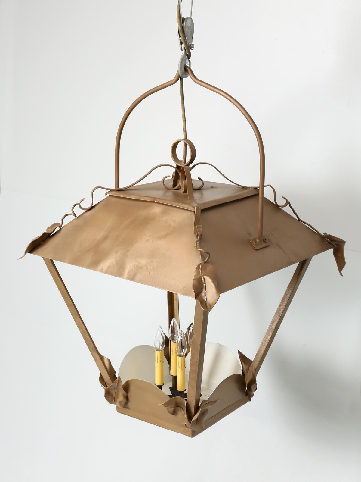 Vintage French lantern in an unusually large size with a leaf motif. The lantern was probably made during the 1950’s and has (4) new American candelabra sockets, along with replaced wiring. The exterior is cold plated bronze and there is no glass,