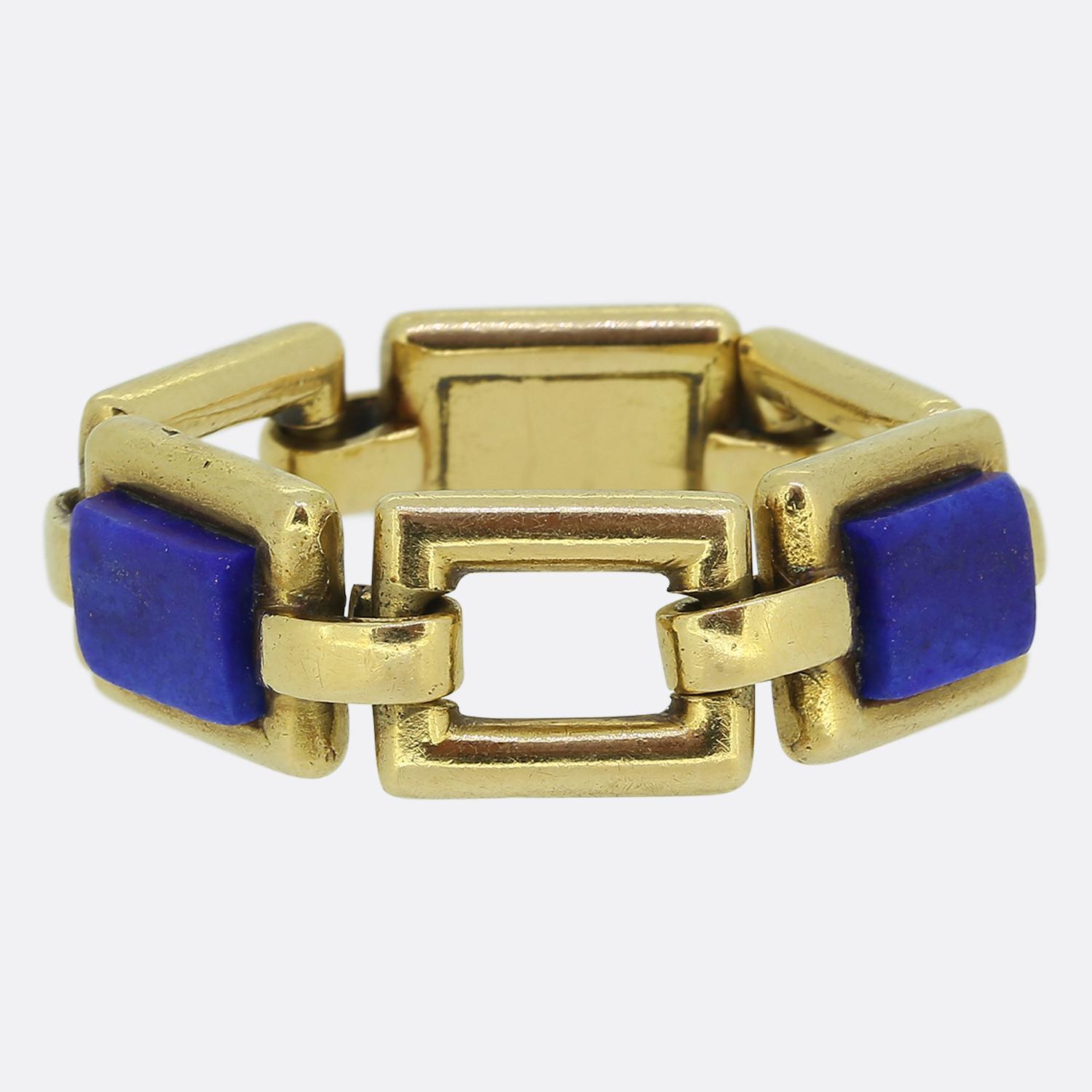 Here we have a unique chain link ring. This vintage piece was crafted in France and showcases a bold design set with a trio of centralised rectangular lapis lazuli stones, all exuding a deep blue hue. The stones are seamlessly integrated into a rich