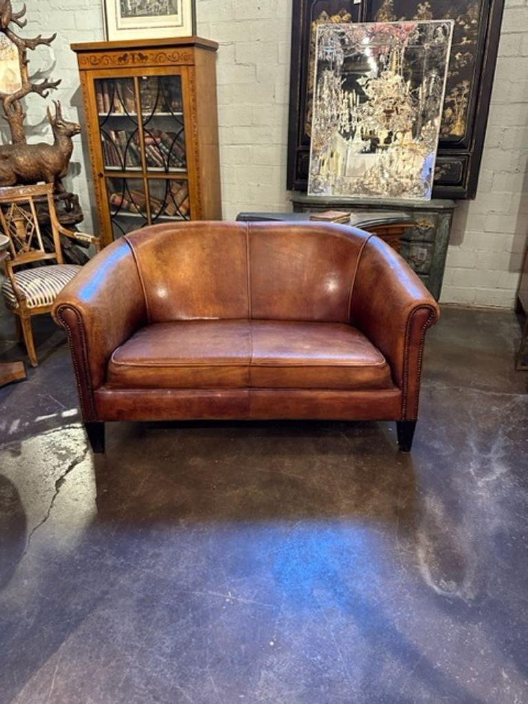 Handsome vintage French leather club settee. Circa 1940. Perfect for today's transitional designs!