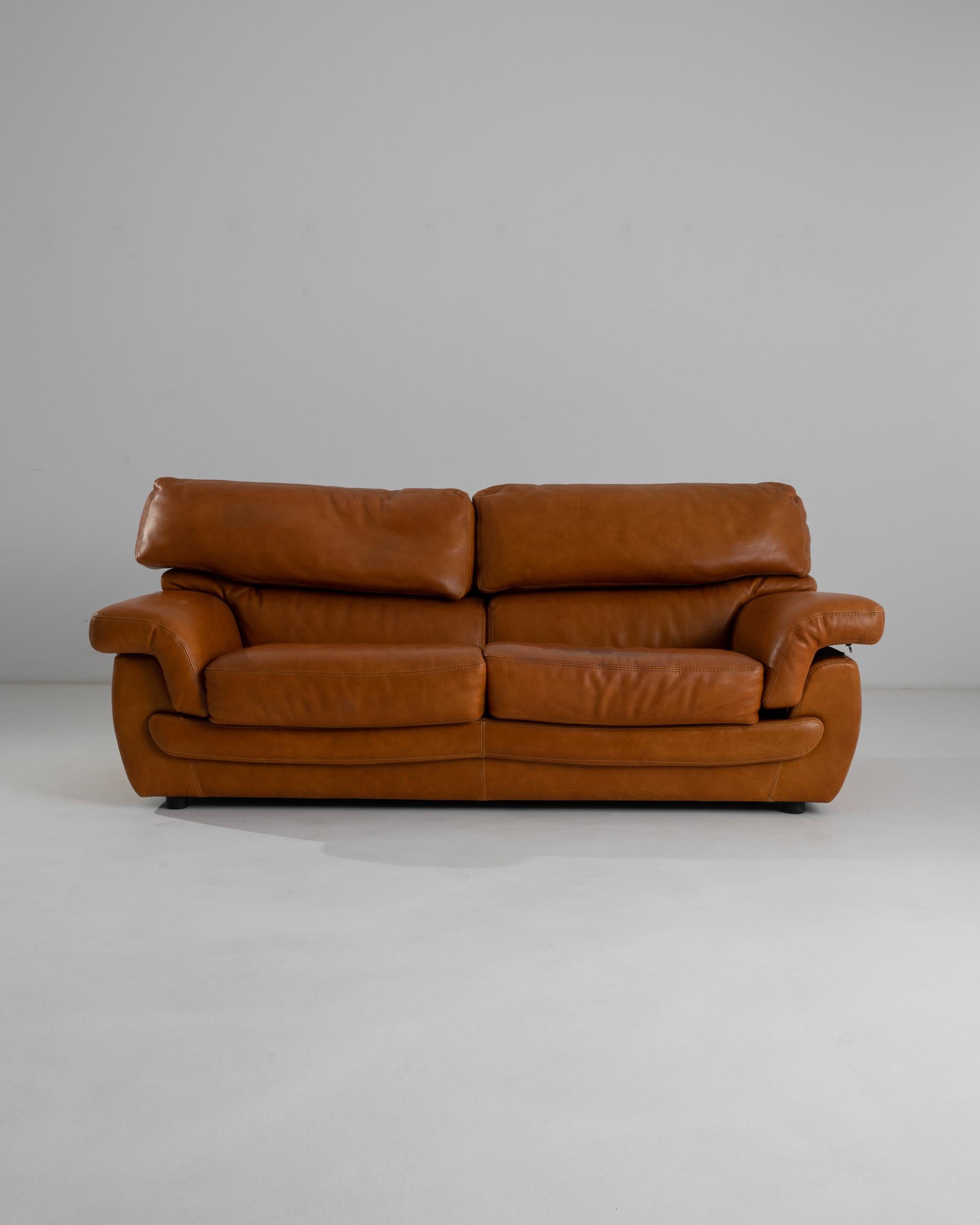 Butter-soft leather and a luxurious design make this midcentury sofa a covetable vintage find. Made in France in the 20th century, the silhouette is both streamlined and relaxed: wide curves and bold angles create an impression of Modernist