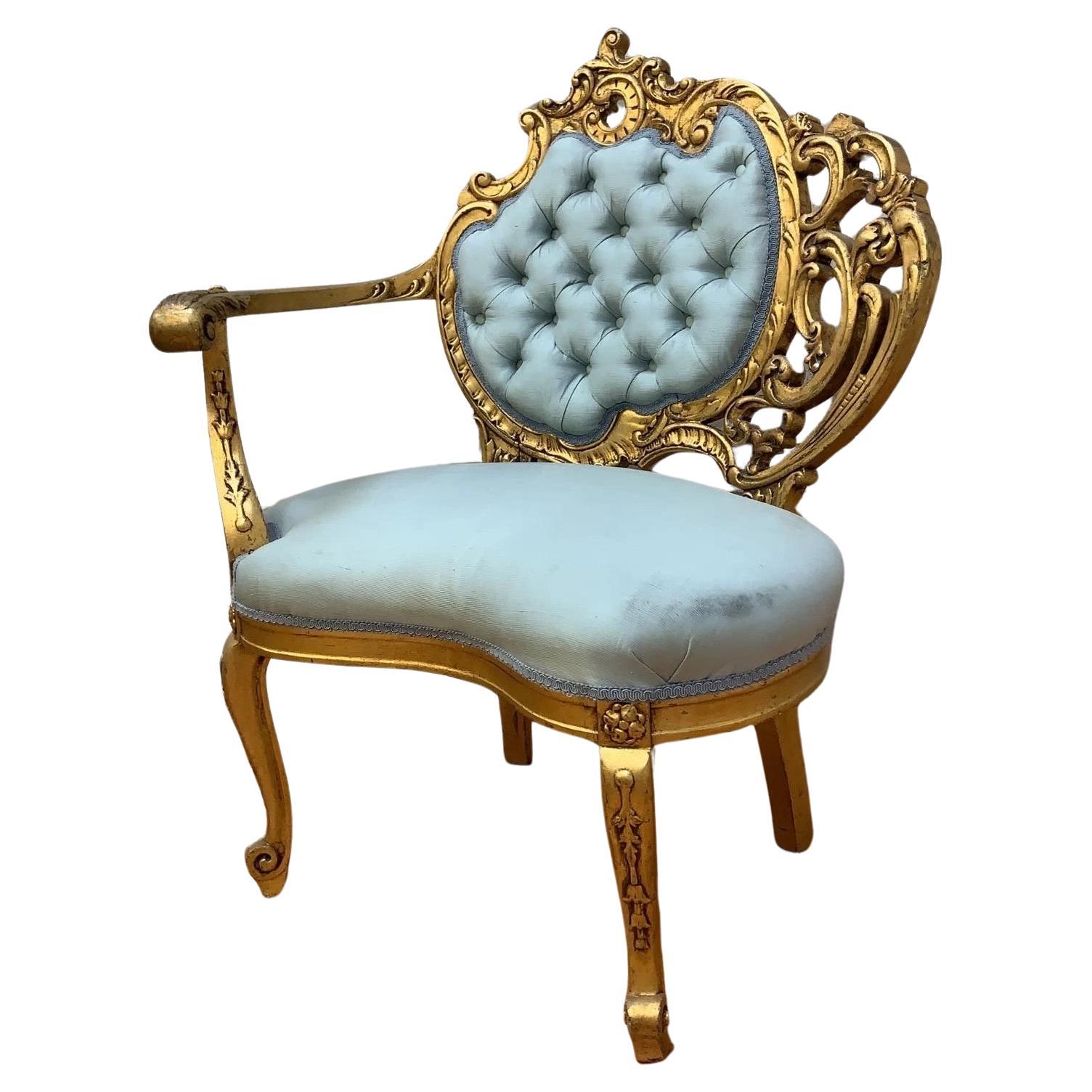 Vintage French Louis Style Carved Asymmetrical Gold-Gilded Baroque Revival Blue Silk Tufted-Back Single Arm Accent Chair 

Our vintage asymmetrical Baroque revival accent chair is a true masterpiece of elegance and sophistication. This chair