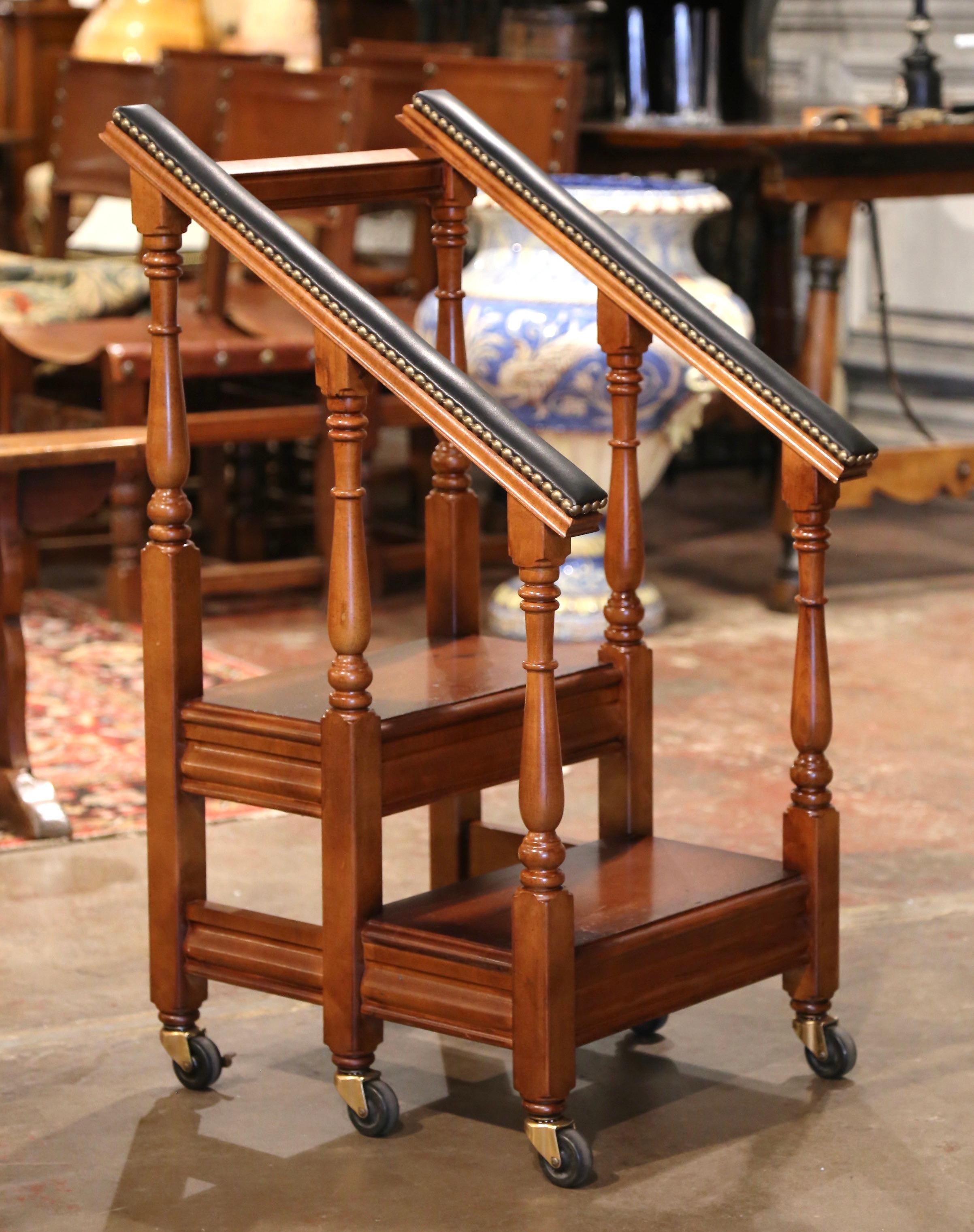 Use this vintage fruitwood step ladder on wheels to organize books in your office or study. Created in France circa 1980 and standing on six turned legs ending with brass coasters with locking mechanism, the antique ladder features two stairs with