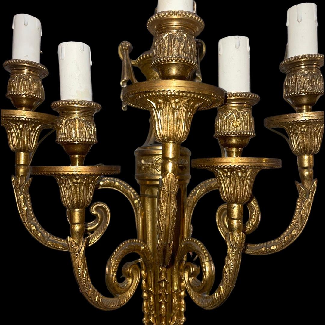 The Vintage French Brass Louis XV Style 5-Arm Wall Lights, the epitome of elegance and sophistication. In the period of the distinguished Louis XV era, these stunning wall lights effortlessly bring a touch of vintage charm to any interior