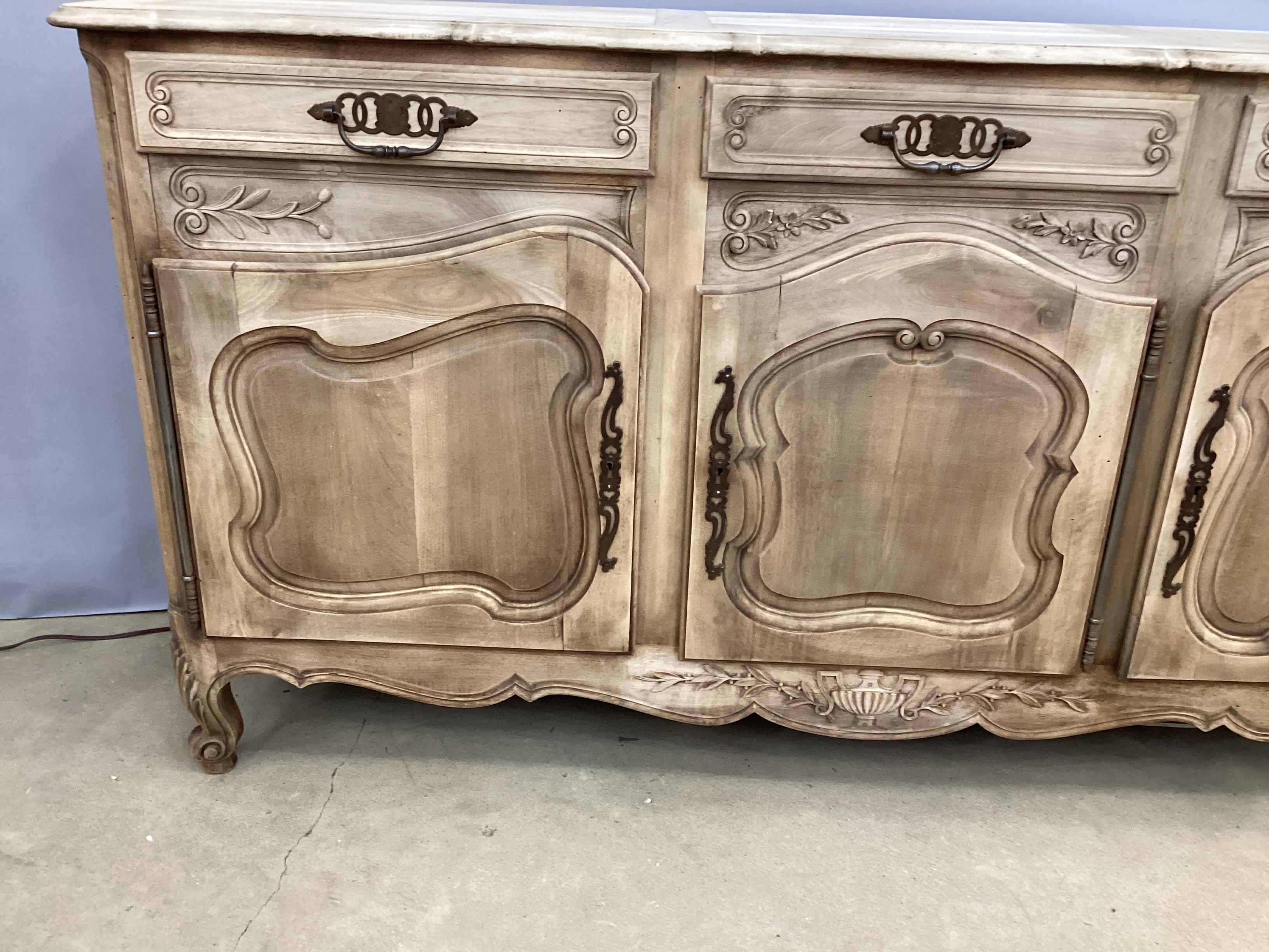 Vintage French Louis XV Style Bleached Buffet. Three drawers over a bottom compartment with three doors with operational locks. Each drawer and door are fitted with cast iron hardware. 