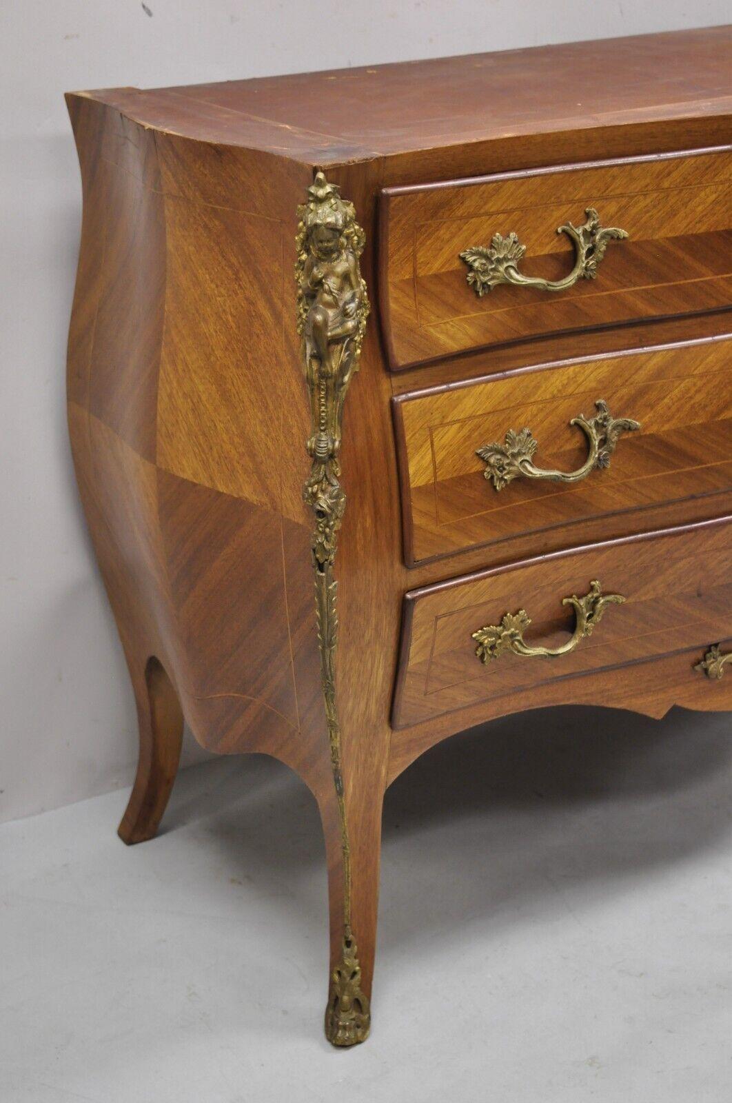 Vintage French Louis XV style bombe commode chest of drawers with cherub figures. Item features bronze ormolu, shapely bombe form, cherub figures to sides, beautiful wood grain, no key, but unlocked, 3 dovetailed drawers, cabriole legs. Marble top