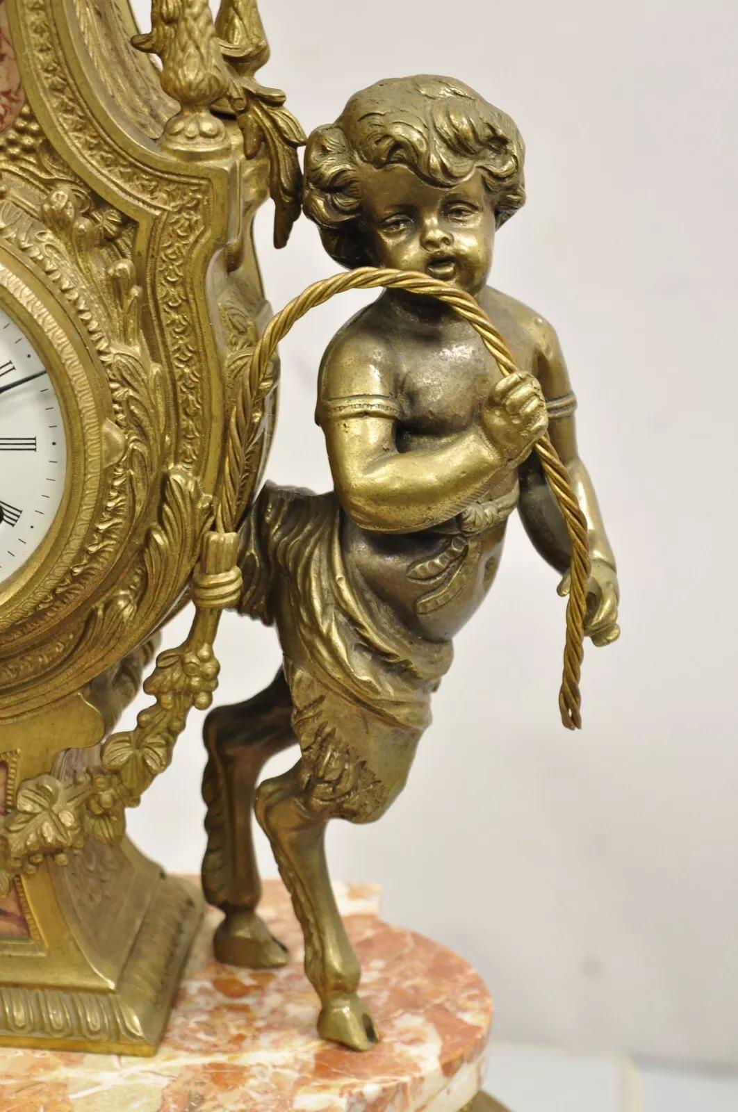 Vintage French Louis XV Style Brevetatto Italy Brass and Marble Figural Cherub Clock. Item features an ornate figural clock with hoof foot cherubs and pink marble accents, German clock movement (has not been tested). Very impressive clock. Circa