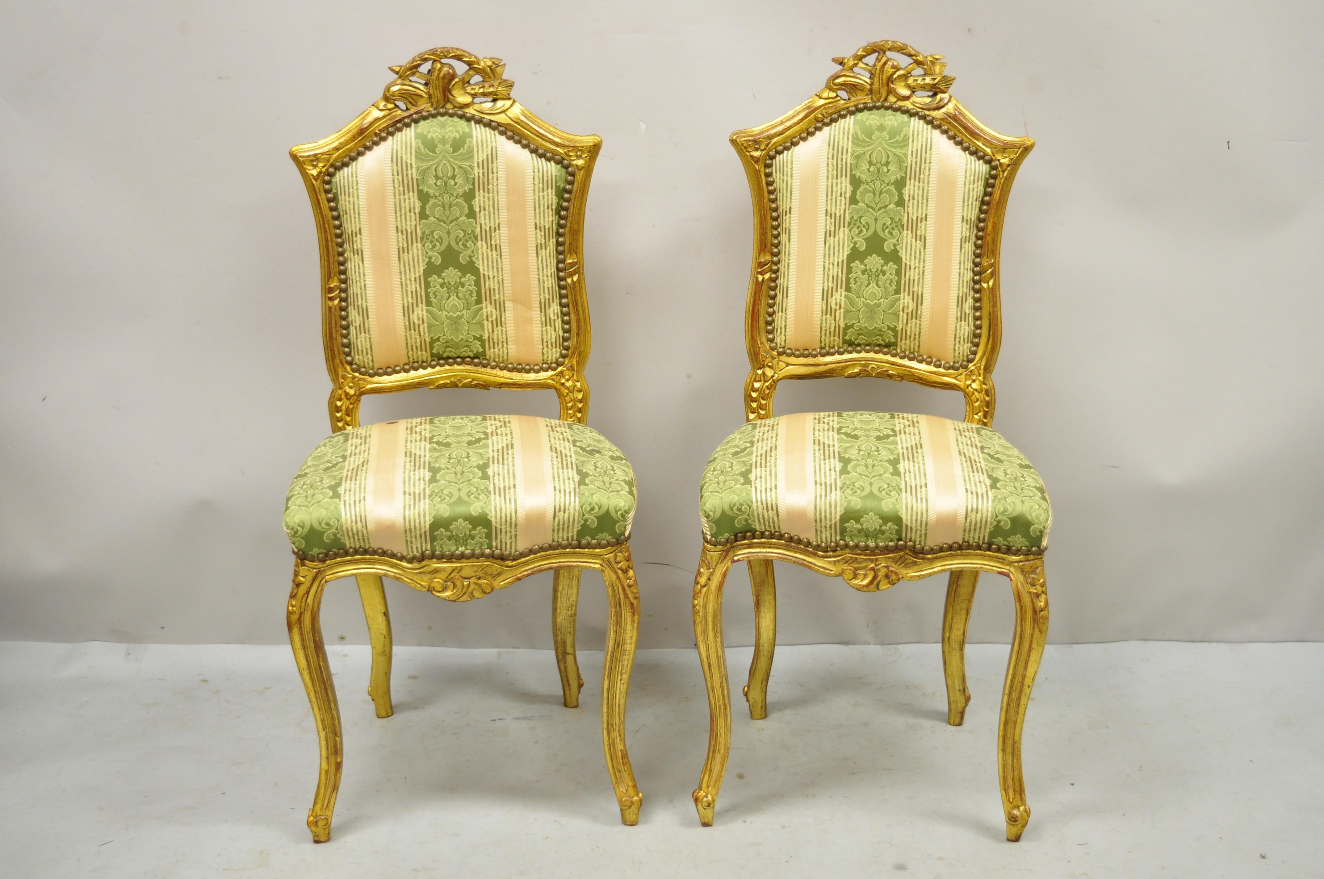 Vintage French Louis XV style goldwood gilt carved boudoir side chairs - a pair. Item features gold gilt finish, solid wood frames, nicely carved details, cabriole legs, great style and form. Nice smaller boudoir size. Circa late 20th century.