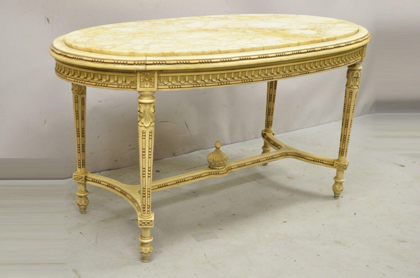 Vintage French Louis XV Style Oval Marble Top Yellow Beige Coffee Table. Item features an inset oval marble top, stretcher base, green and gold painted finish, solid wood frames, nicely carved details, very nice vintage item, great style and form.