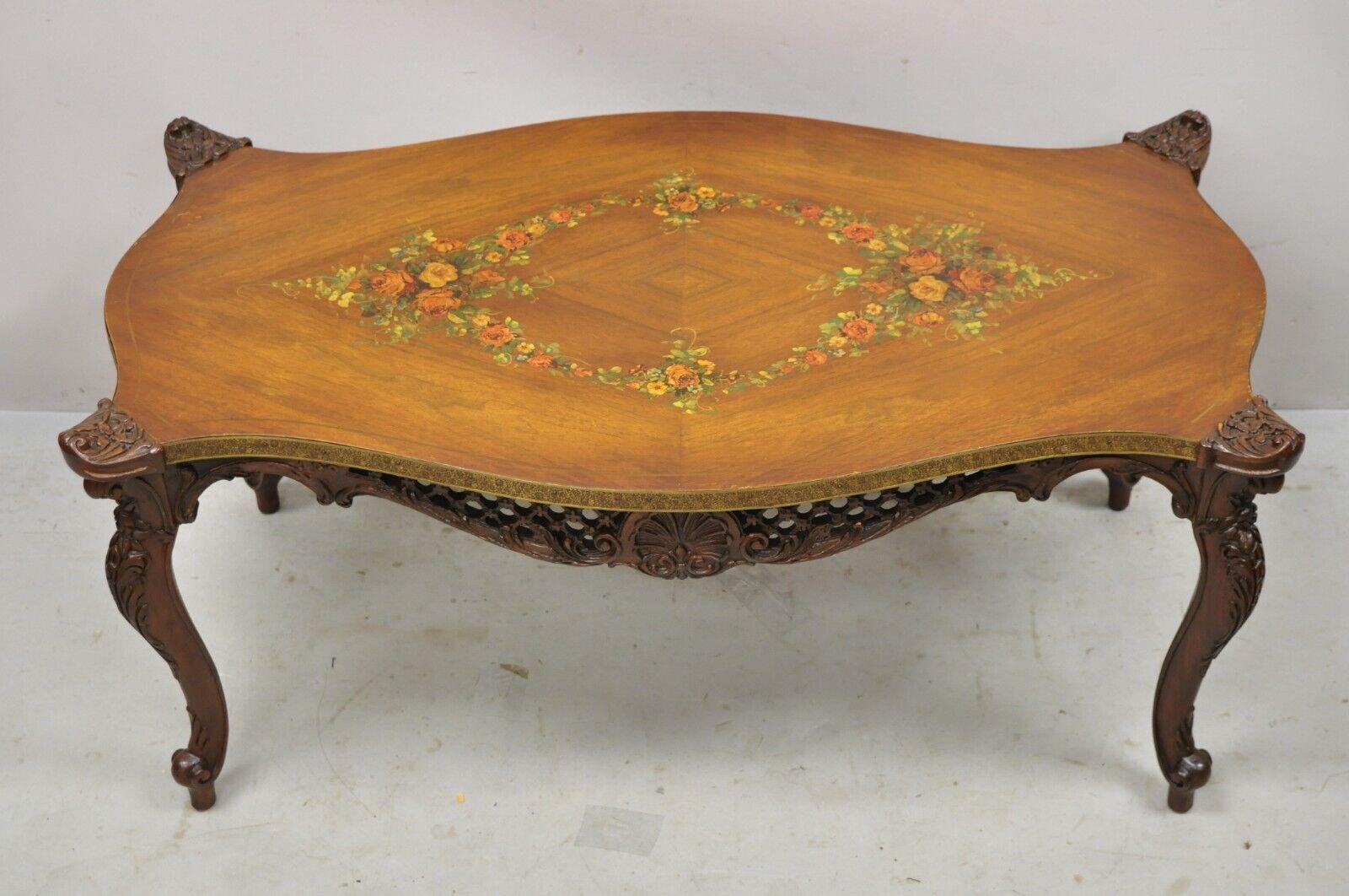 Vintage French Louis XV style walnut coffee table with hand painted floral top. Item features a pierce carved fretwork skirt, decorated brass rim, shaped top, hand painted floral top, cabriole legs, very nice vintage item, great style and form.