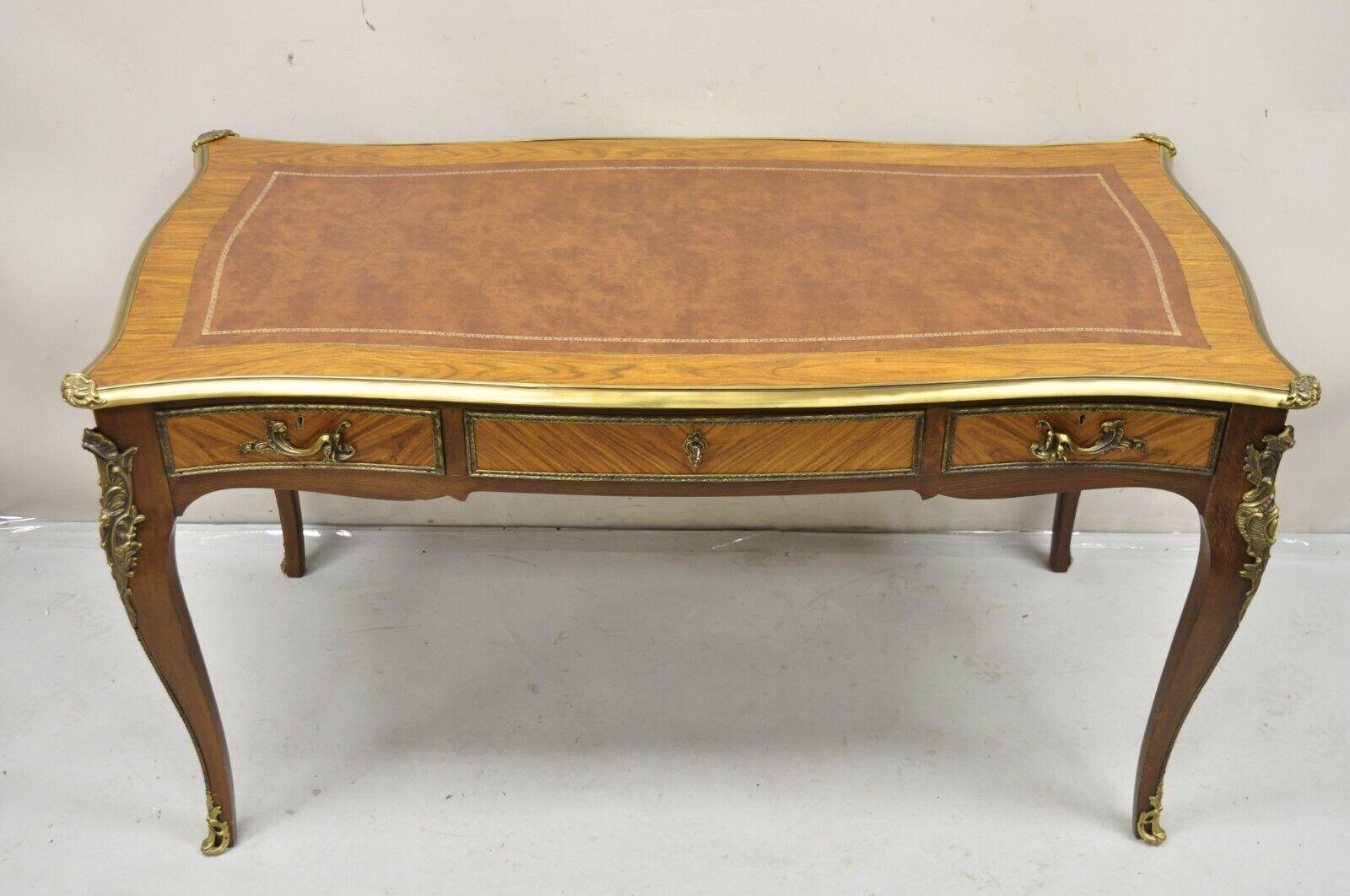 Vintage French Louis XV Style Walnut Leather Top Bronze Ormolu Writing Desk. Item features a working lock and key, 3 faux drawers to rear, bronze ormolu, tooled leather top, beautiful wood grain, very nice vintage item. Circa Mid 20th Century.