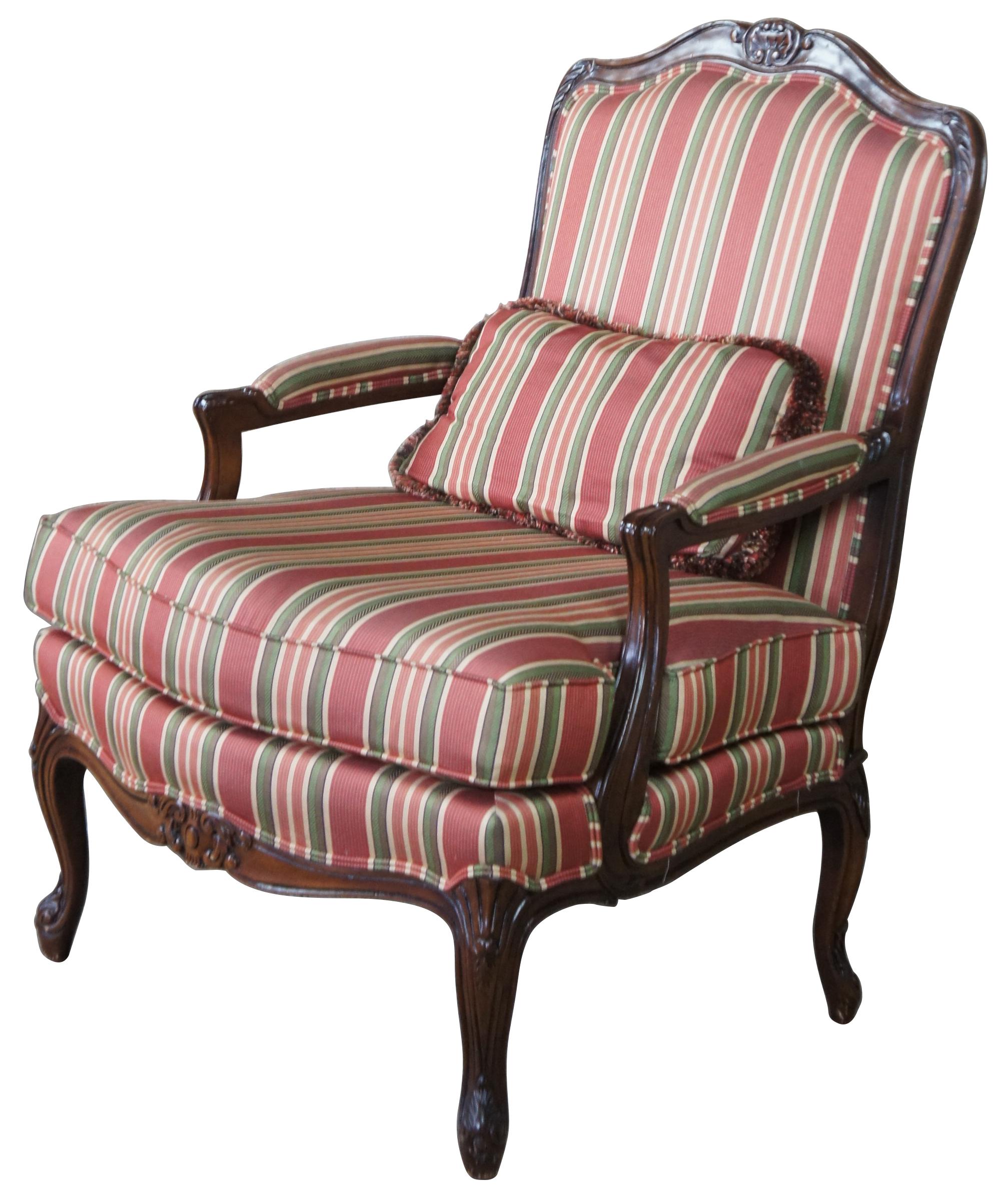 Vintage French Louis XV library club chair. Made of walnut with serpentine form, padded arms, cabriole legs and a striped upholstery accented with double piping. Matching lumbar pillow with fringe included.
 