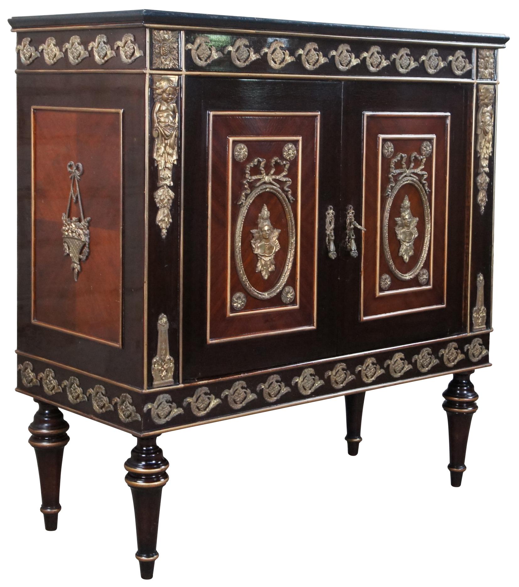 Vintage French Louis XVI inspired petite buffet, bar cabinet, commode, hall console or server. Made in Cairo Egypt (Arabska Republika Egiptu) by Abbas, circa 1972. Made of ebonized mahogany featuring ornate brass medallions, ormolu figural mounts,