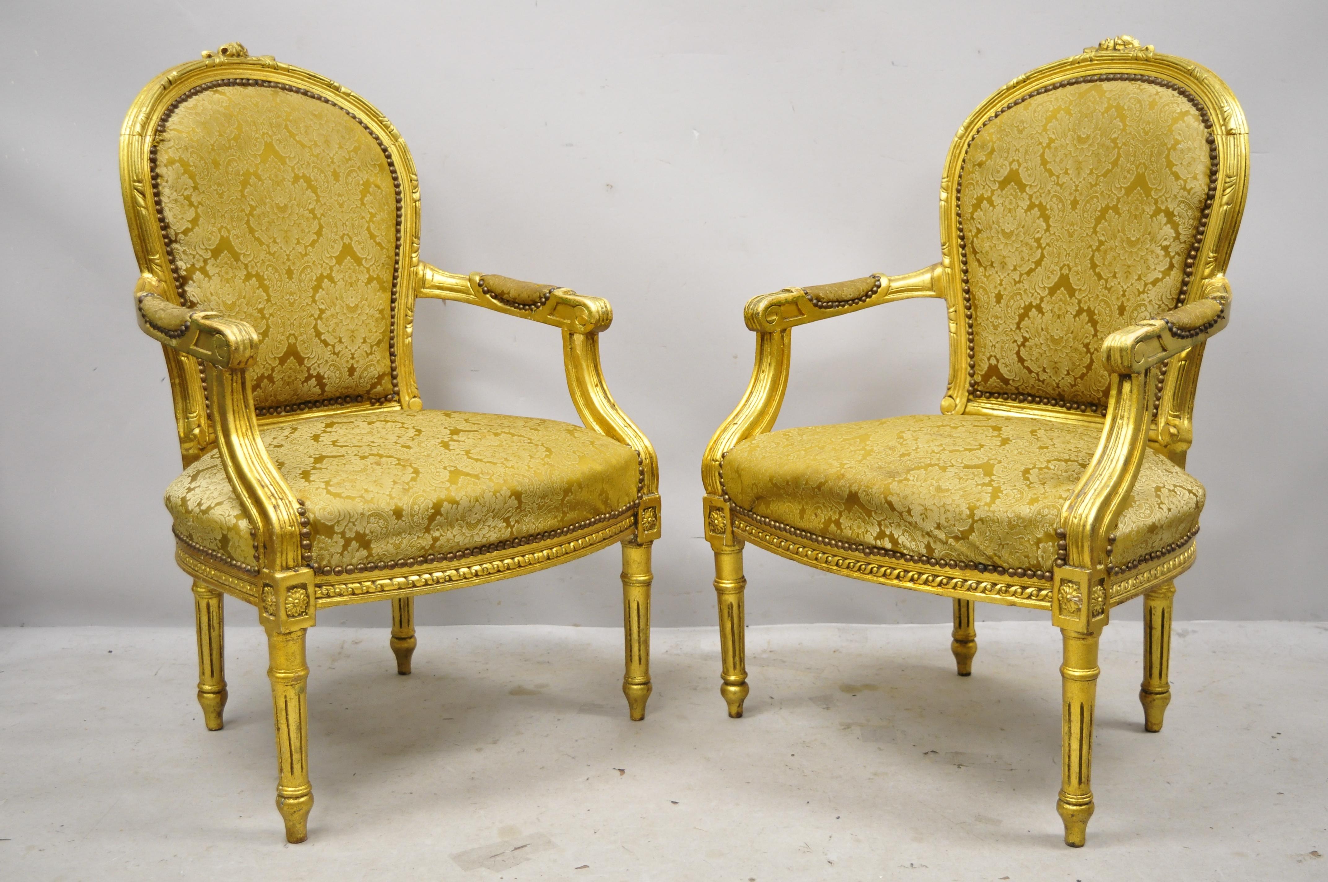 Vintage French Louis XVI style gold leaf balloon back fauteuil armchairs, a pair. Item features distressed gold gilt/solid leaf finish, upholstered armrests, nicely carved details, cabriole legs, great style and form, circa mid to late 20th century.