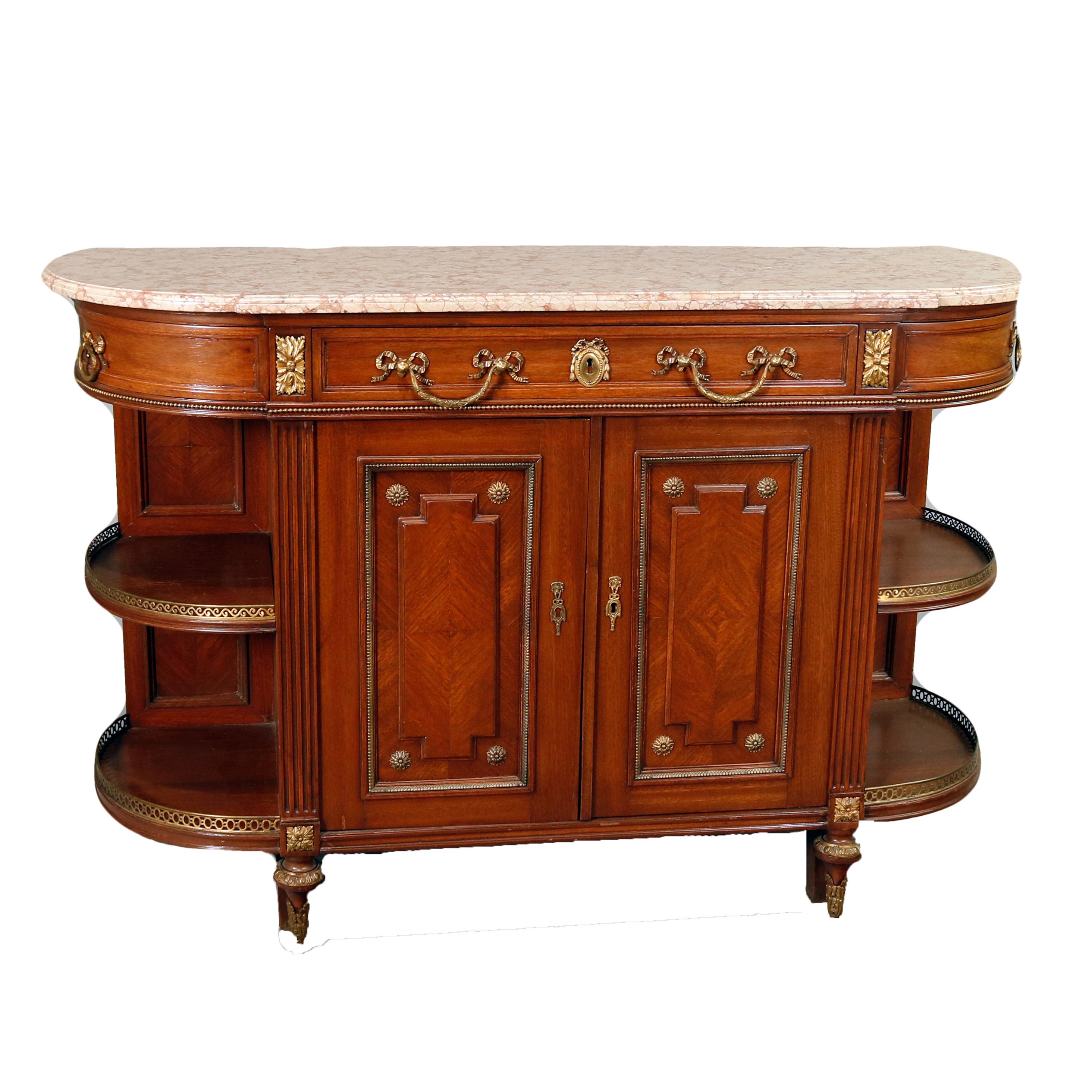 A vintage French Louis XVI sideboard offers shaped and beveled top surmounting mahogany demilune form case having frieze with two central drawers flanked by quarter curve drawers over lower double door central cabinet having bookmatched panels with
