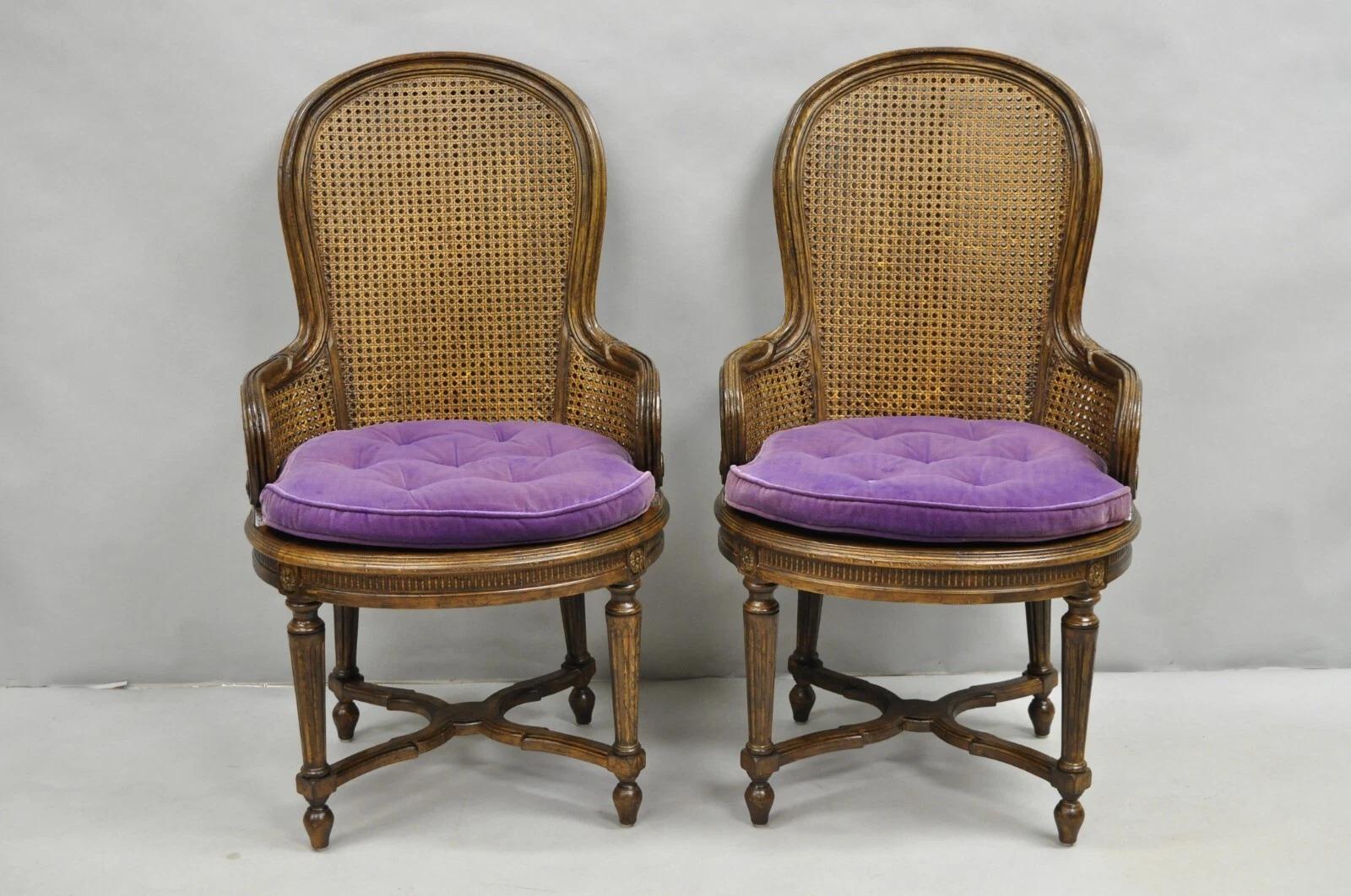 Beautiful Vintage French Louis XVI Style Cane Balloon Back Walnut Arm Chairs with Purple Loose Cushions and Stretcher Base - a Pair. Circa Mid 20th Century. Measurements: 39