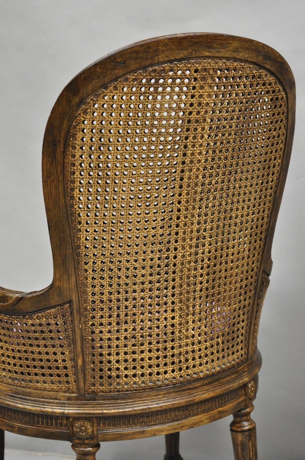 Vintage French Louis XVI Style Cane Balloon Back Walnut Arm Chairs - a Pair in vendita 1