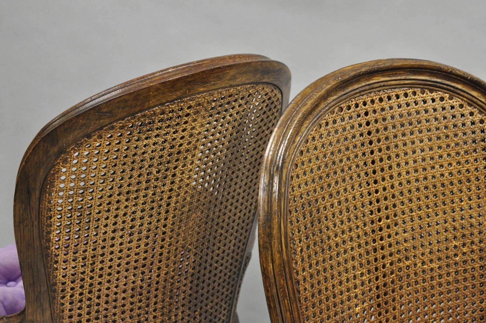 Vintage French Louis XVI Style Cane Balloon Back Walnut Arm Chairs - a Pair in vendita 2