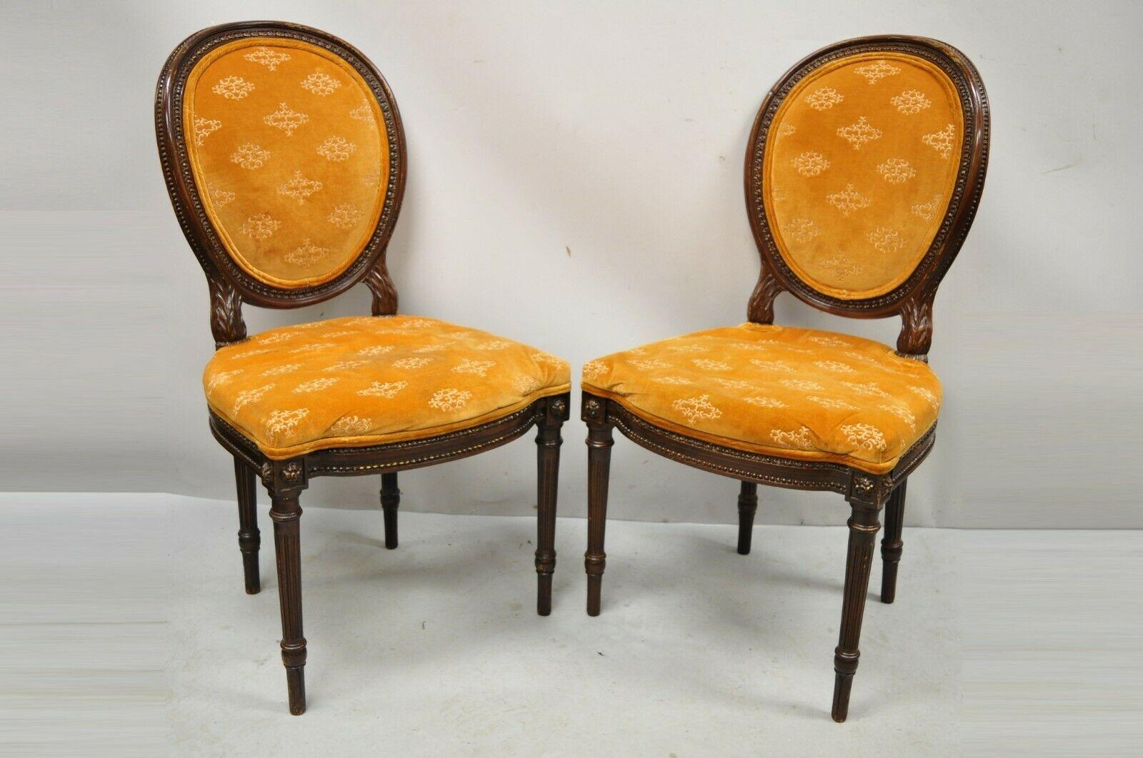 Vintage French Louis XVI Style Carved Wood Oval Back Dining Side Chairs - a Pair. Item features carved wood frames, upholstered oval backs, solid wood frames, nicely carved details, tapered legs, great style and form. Circa Mid 20th Century.