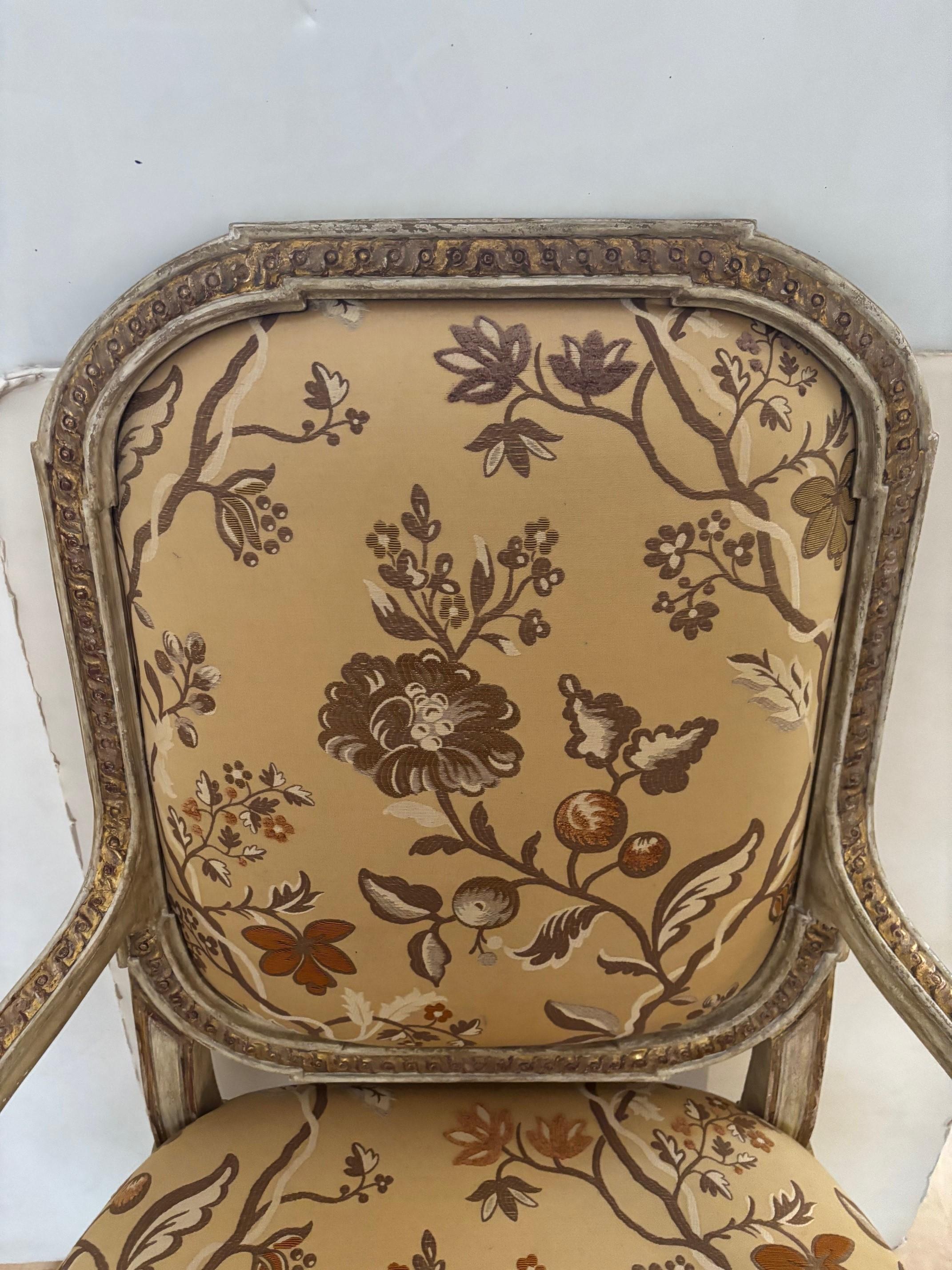 Vintage French Louis XVI Style Fauteuil, Carved Oval Back Antique Painted Finish with Gilded Accents Upholstered in Floral Material

