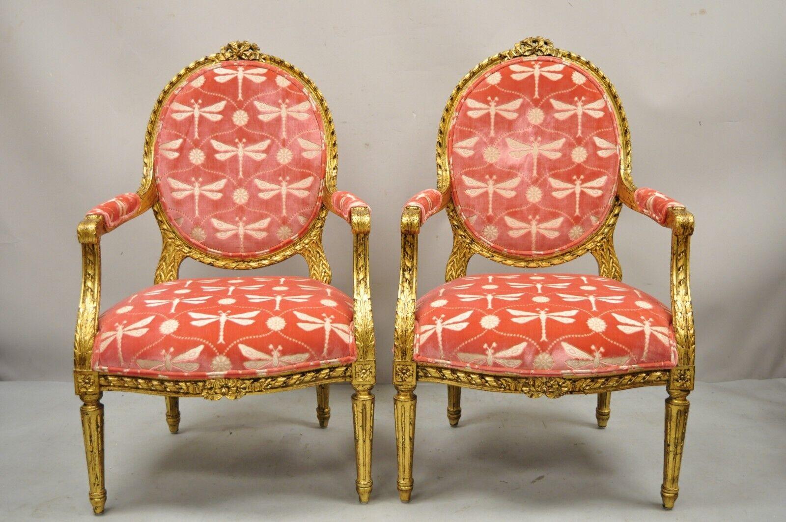 Vintage French Louis XVI Style Gold Giltwood Pink Arm Chairs - a Pair. Item features pink butterfly upholstery, gold leaf solid wood frames, upholstered armrests, distressed finish, tapered legs, very nice vintage pair. Circa mid to late 20th