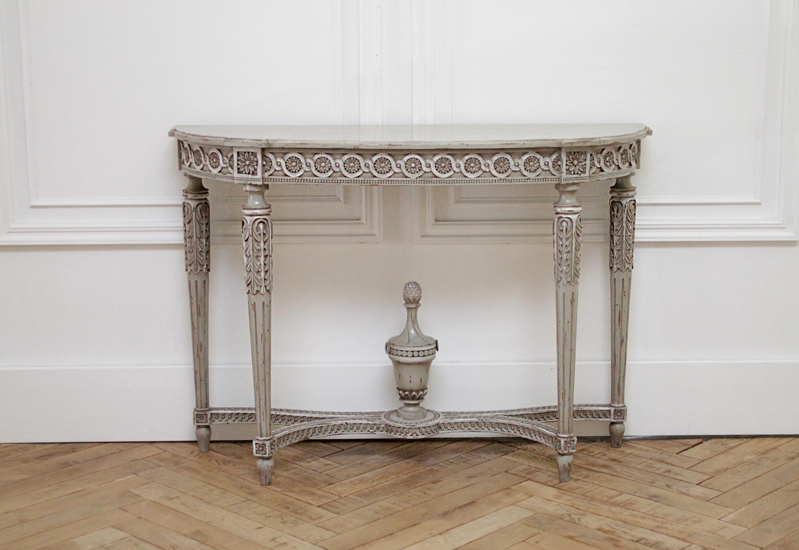 Vintage French Louis XVI style original painted and carved console table
Beautiful painted with original French gray tone, with an antique patina. This console is free standing and does not need to be attached to a wall. Legs are a nice tapered