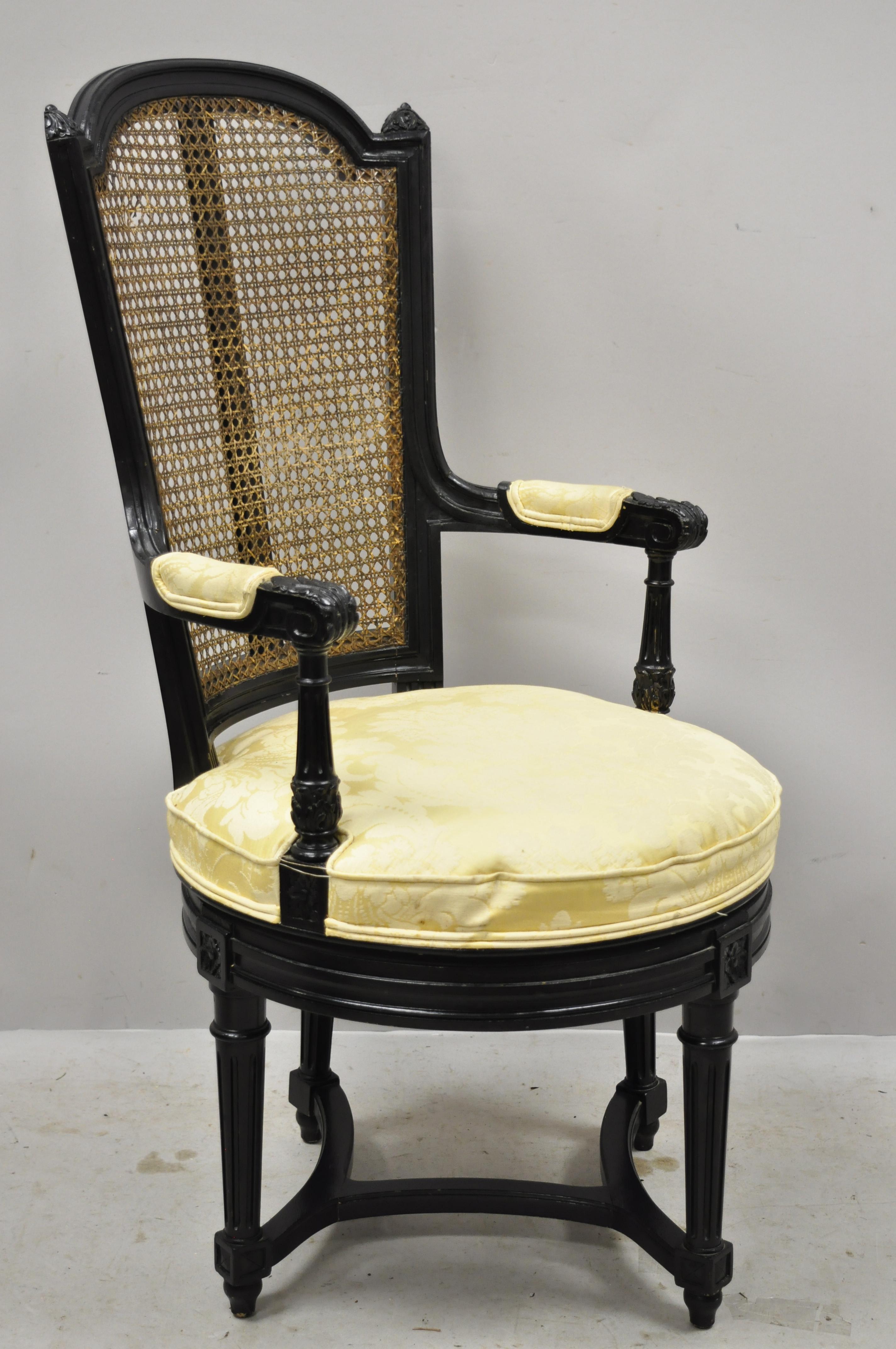 Vintage French Louis XVI style swivel seat cane back black ebonized vanity chair. Item features a swivel seat, cane back, stretcher base, solid wood frame, upholstered arm rests, nicely carved details, tapered legs, very nice antique item, great