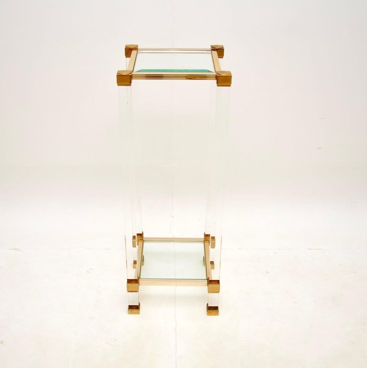 A smart and stylish vintage French lucite and glass side table by Pierre Vandel. This was made in Paris, it dates from around the 1970’s.

It is of lovely quality, with a thick lucite frame and brass plated aluminium supports. The top and lower