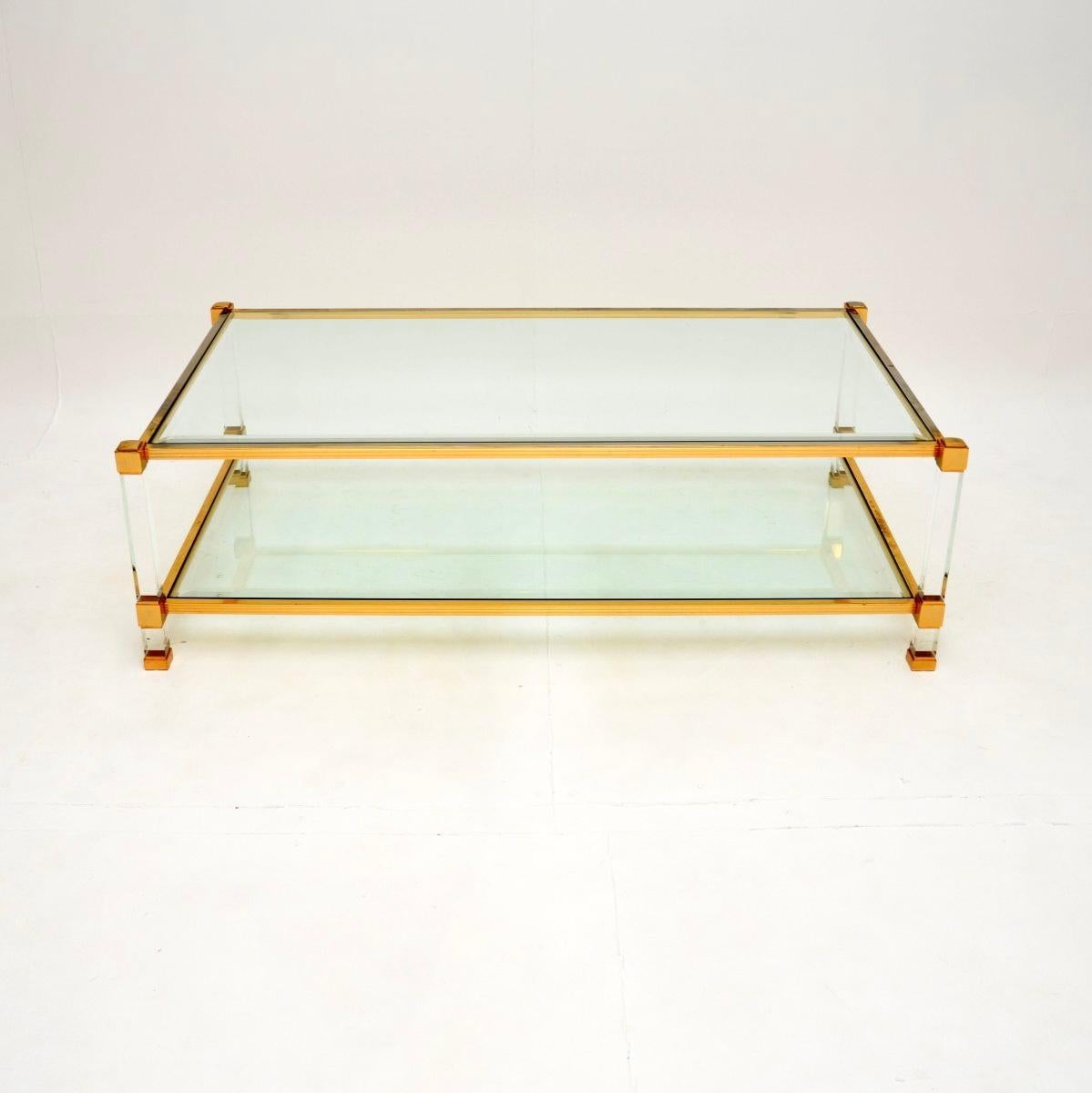 A large, stylish and extremely well made vintage French Lucite and gold plated coffee table, dating from the 1970’s.

The design is very similar to models by Pierre Vandel that we have had, though it is actually far superior quality. Rather than the