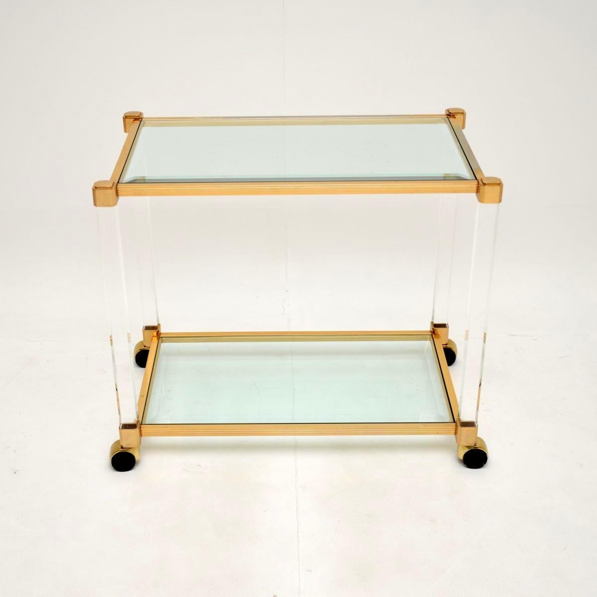 A stylish and extremely well made vintage French Lucite and gold plated drinks trolley, dating from the 1970’s.

The design is very similar to models by Pierre Vandel that we have had, though it is actually far superior quality. Rather than the
