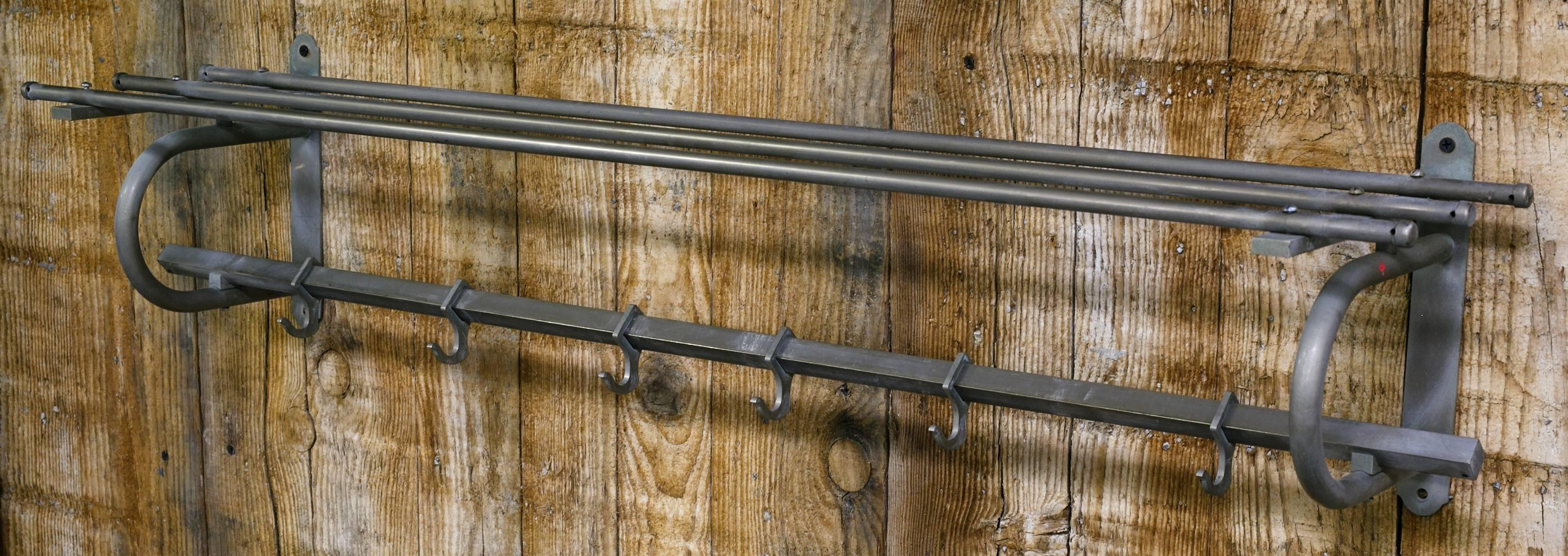 This vintage rack has 6 hooks in addition to the shelf.
It is nickel plate over brass. It has developed a nice patina.