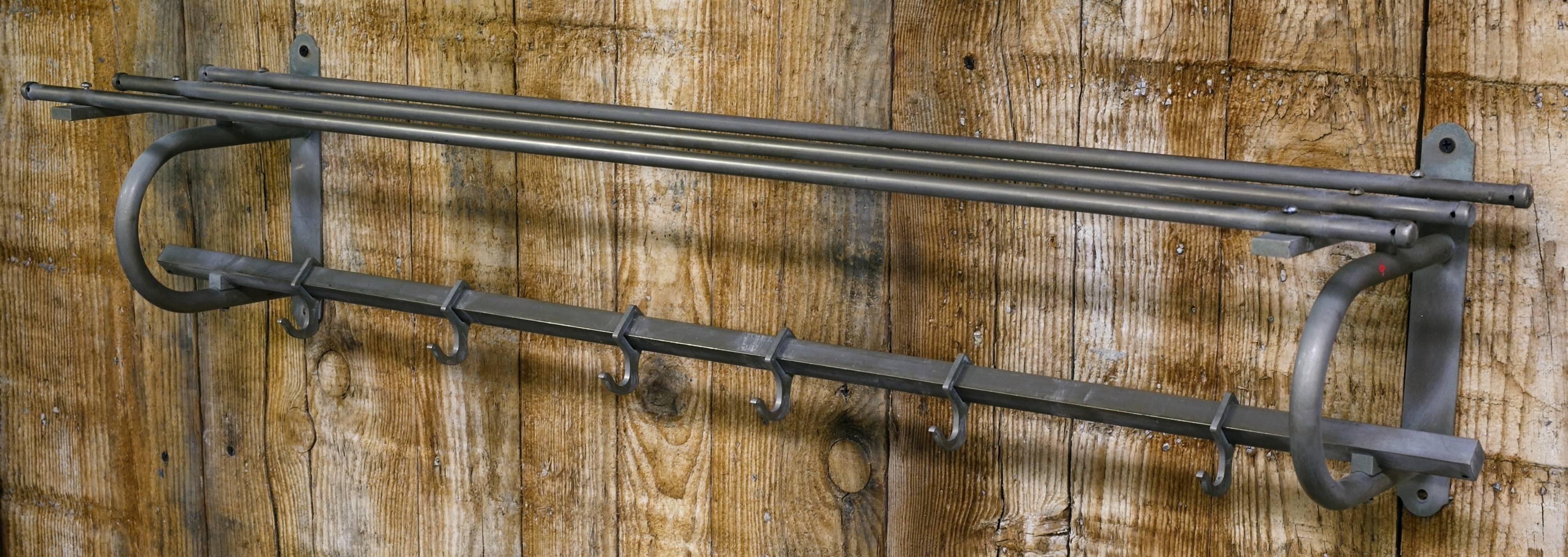 This vintage rack has 6 hooks in addition to the shelf.
It is nickel plate over brass. It has developed a nice patina.