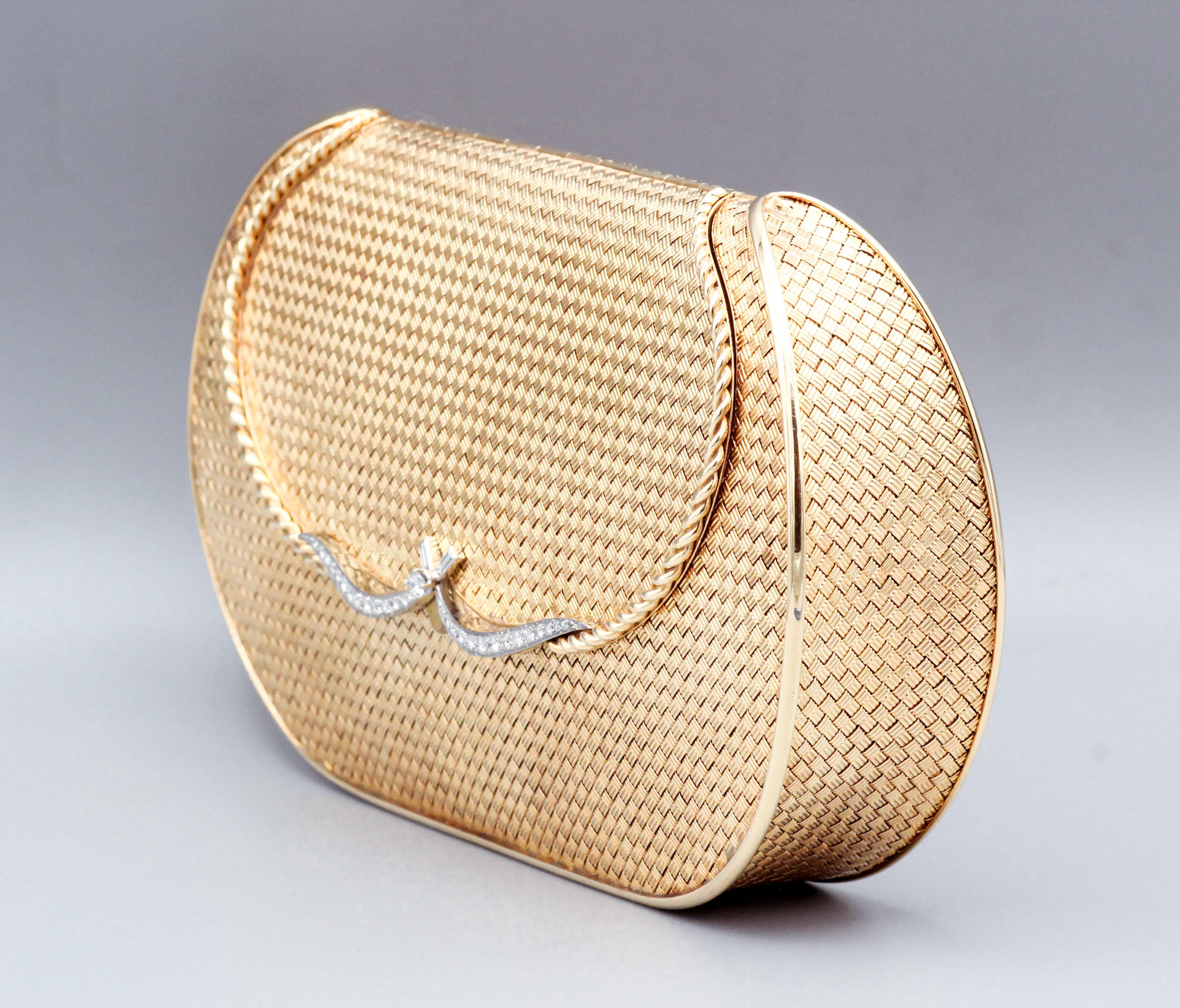 Enter into a world of timeless glamour with this exquisite French-made Diamond set platinum and 18 Karat gold basket eave clutch purse, a true masterpiece of mid-century craftsmanship. Crafted in the 1960s, this piece exudes the elegance and