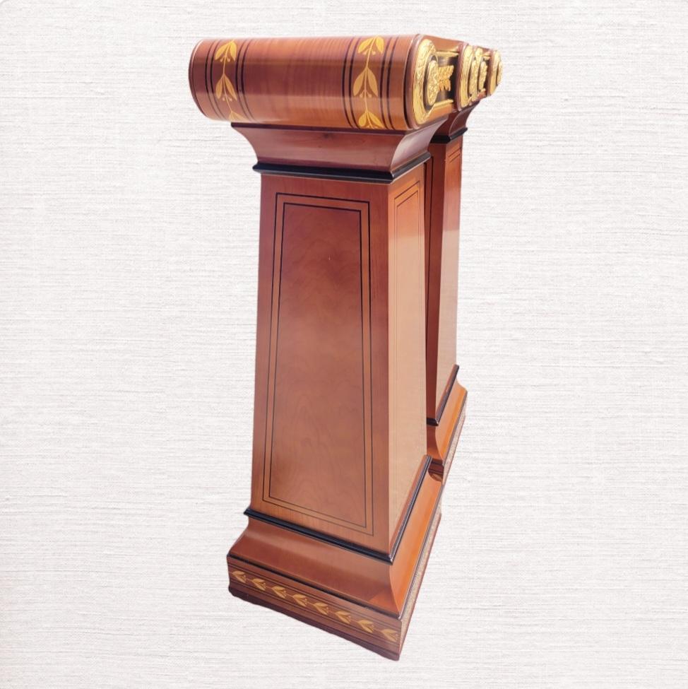 An incredible pair of very large vintage French Louis XVI style highly ornamental pedestal columns.
The pedestal columns are made of beautiful mahogany wood. They're incredibly elegant and adorned with elegant gold gilt ornamental metal leafs in