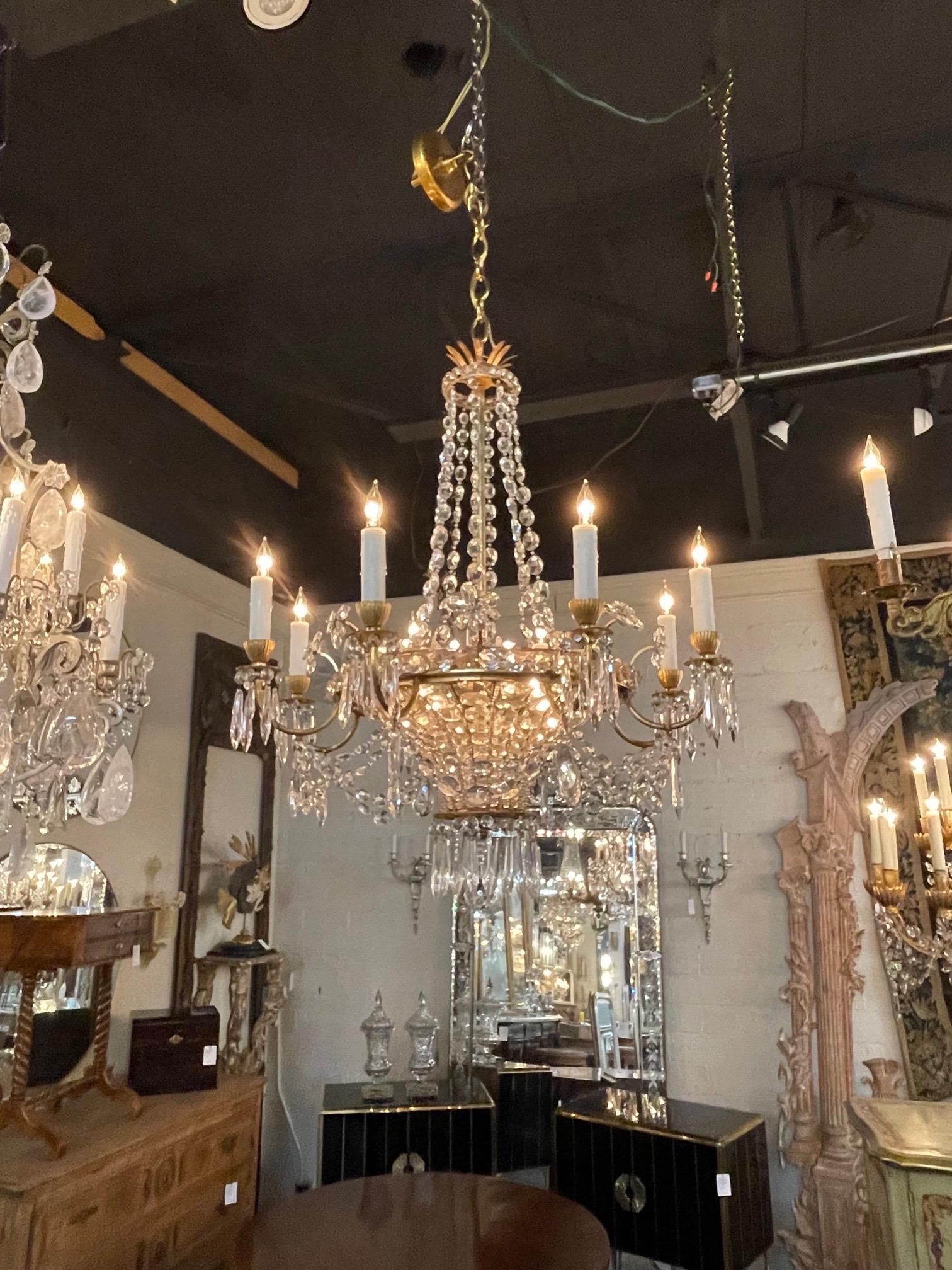 Superb vintage French Maison Bagues gilt bronze and crystal chandelier with 8 arms. Beautiful basket shape along with 8 lights and very fine crystals. An exceptional piece!