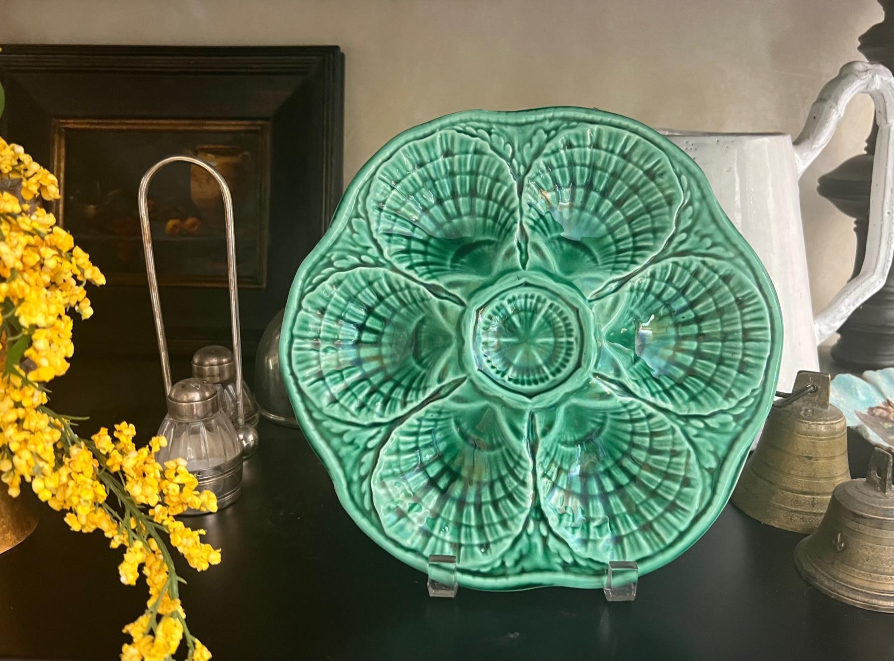 Vibrant green vintage Majolica six well oyster plates made in France by Sarreguemines between the 1930s and 1940s. Each is slightly different in color as they are hand painted, all are stamped Sarreguemines France.