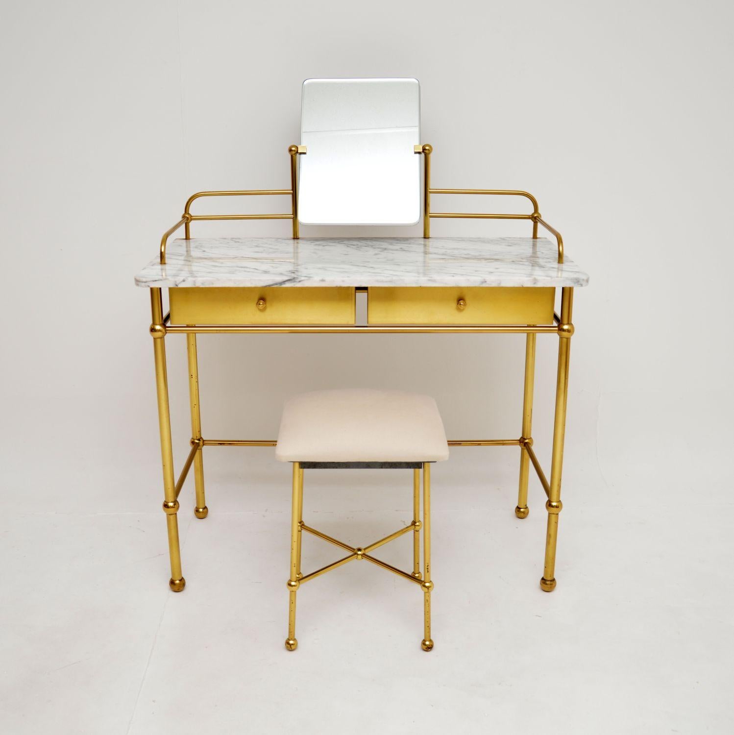 A stunning vintage French marble and brass dressing table by Georges Raimbaud for Resistub, circa 1960’s.

This is of absolutely outstanding quality, with an extremely beautiful and stylish design. This has a polished brass frame with brass fronted