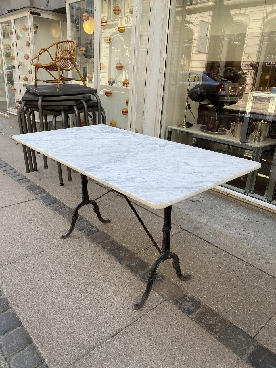 Handsome vintage French bistro table, with an elegant sleek black cast iron underframe and wonderfully large marble top. The slight patina on the surface only adding to the charm.