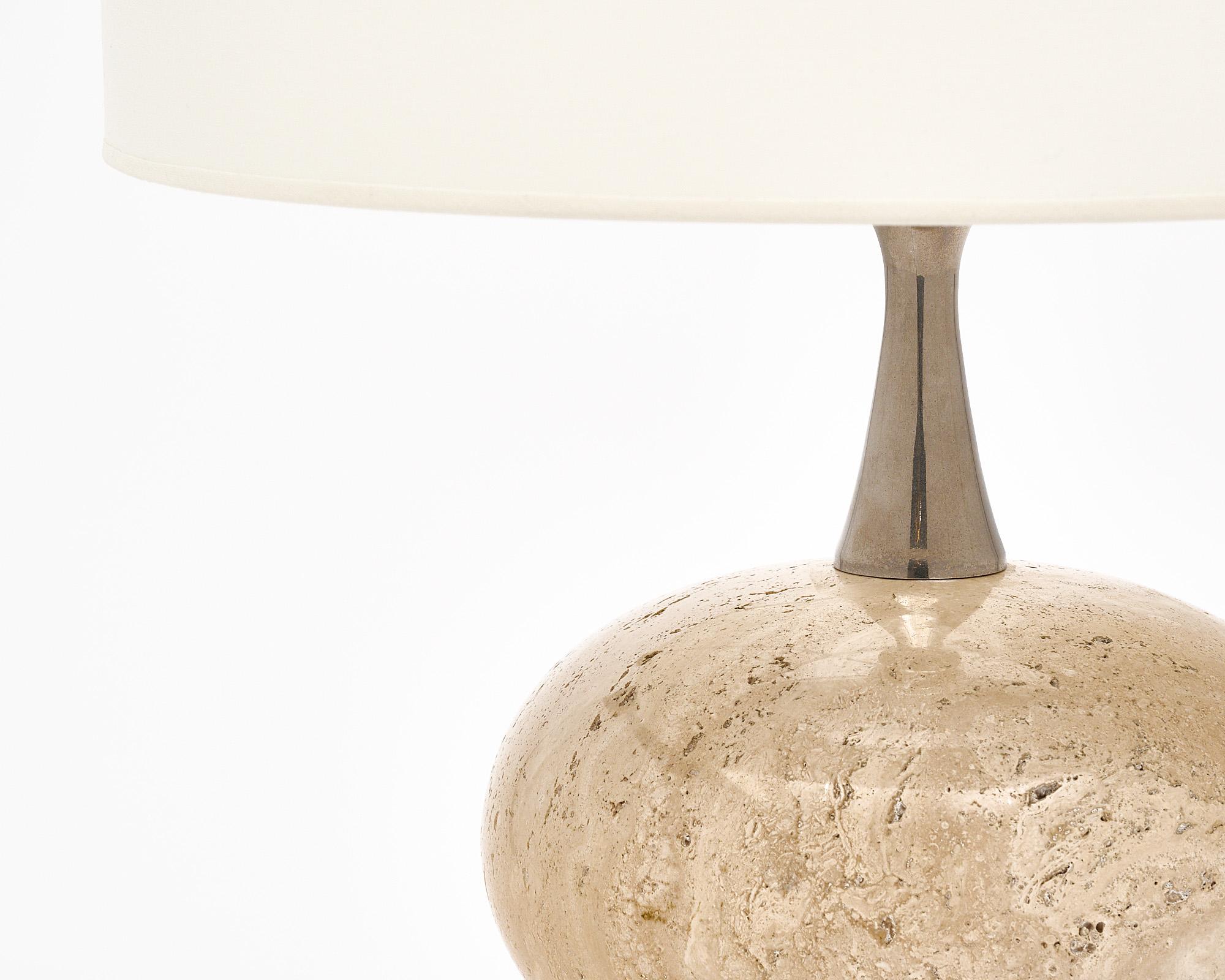 Table lamp made with a orb and base of “Travertin” marble connected with nickel components. The contemporary design is enhanced with the beautiful material this piece is crafted from. It has been newly wired to fit US standards. 
