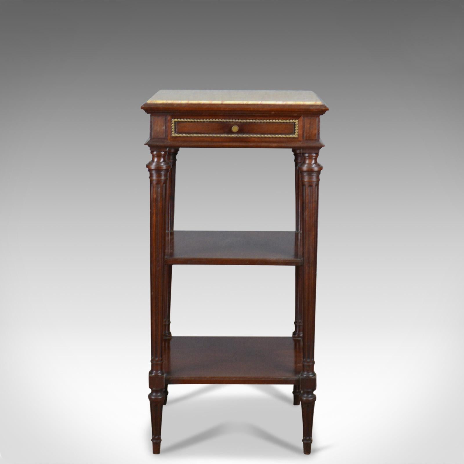 This is an antique French, marble top, bedside table. A French, mahogany display table in the Louis XVI taste by renowned cabinet maker Constantin Potheau of Paris and dating to the early 20th century, circa 1910.

Of superior quality by a fine