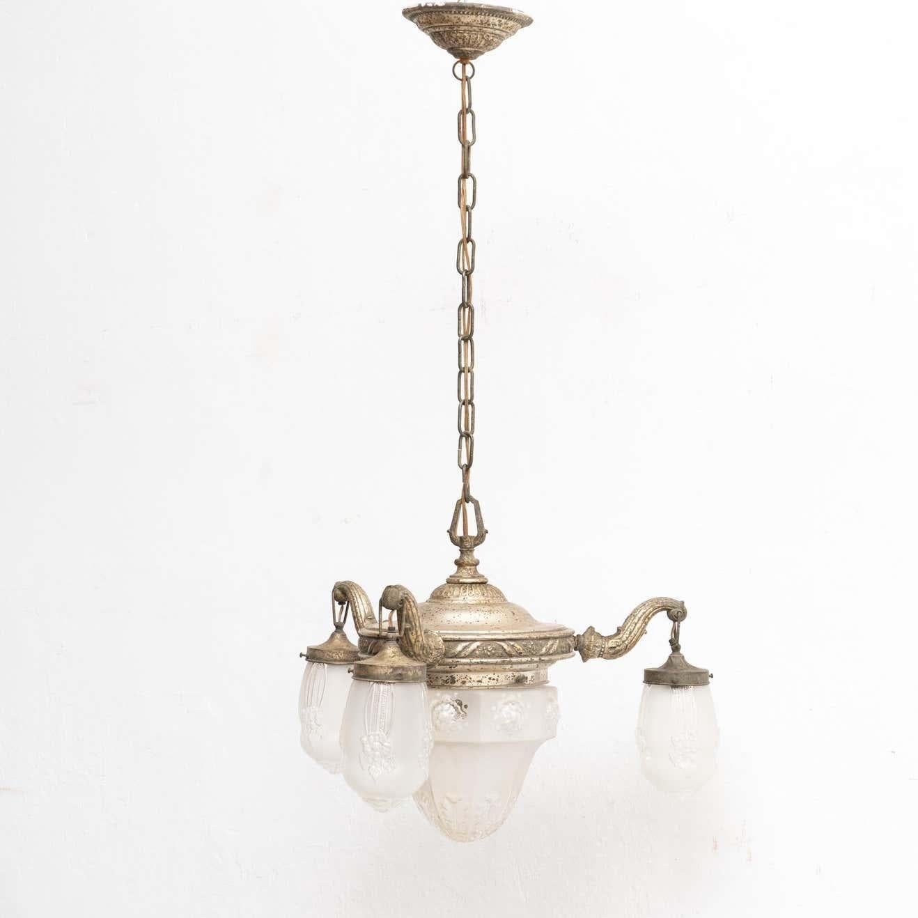 French vintage metal and glass Art Deco hanging lamp.    By unknown manufacturer from France, circa 1930.    In original condition, with minor wear consistent with age and use, preserving a beautiful patina.    Materials:  Glass  Metal. 