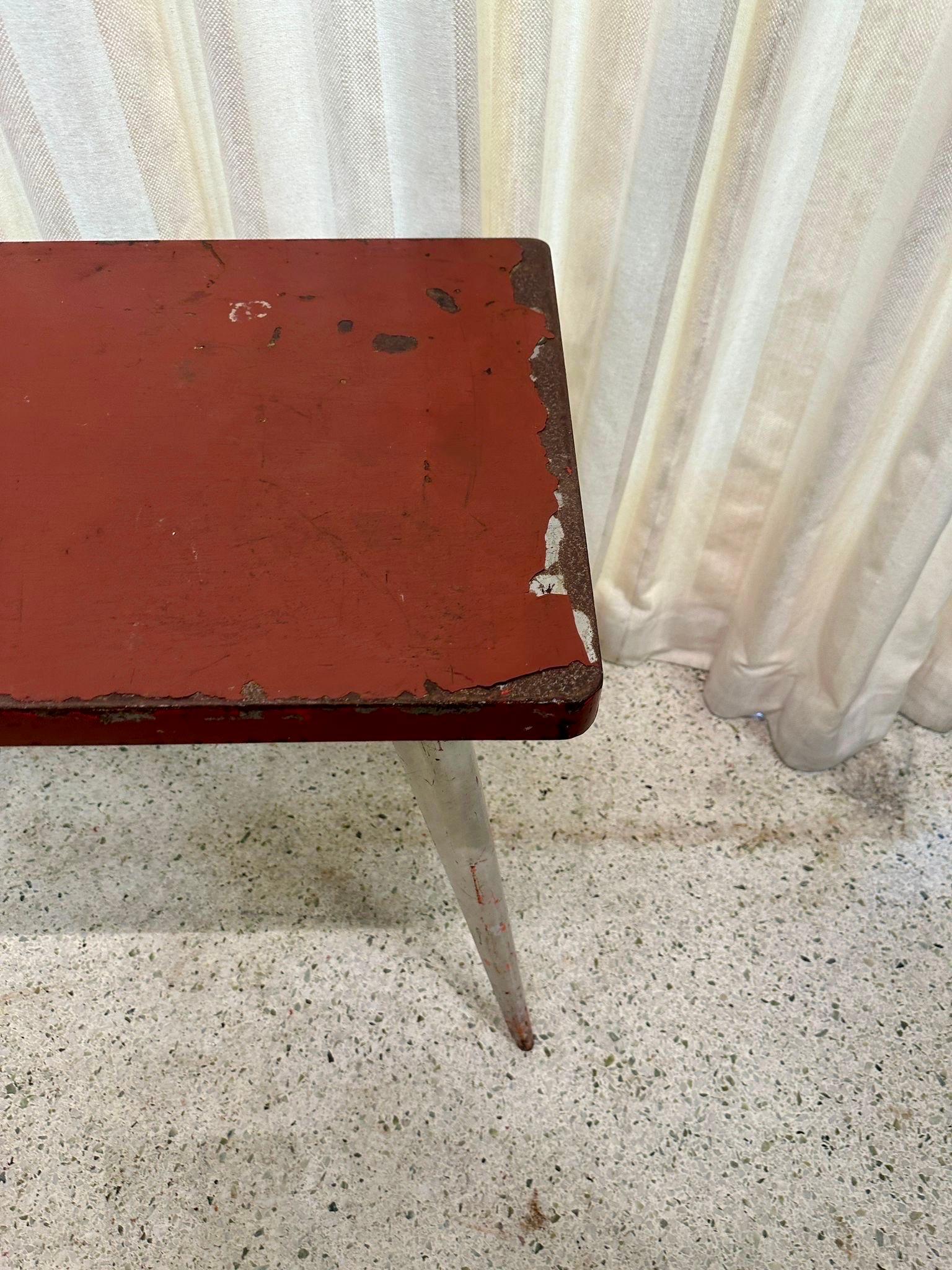 This vintage French bistro table designed by Xavier Pauchard, but very much in the style of Jean Prouve with tapering sword legs and ALL original colors.  