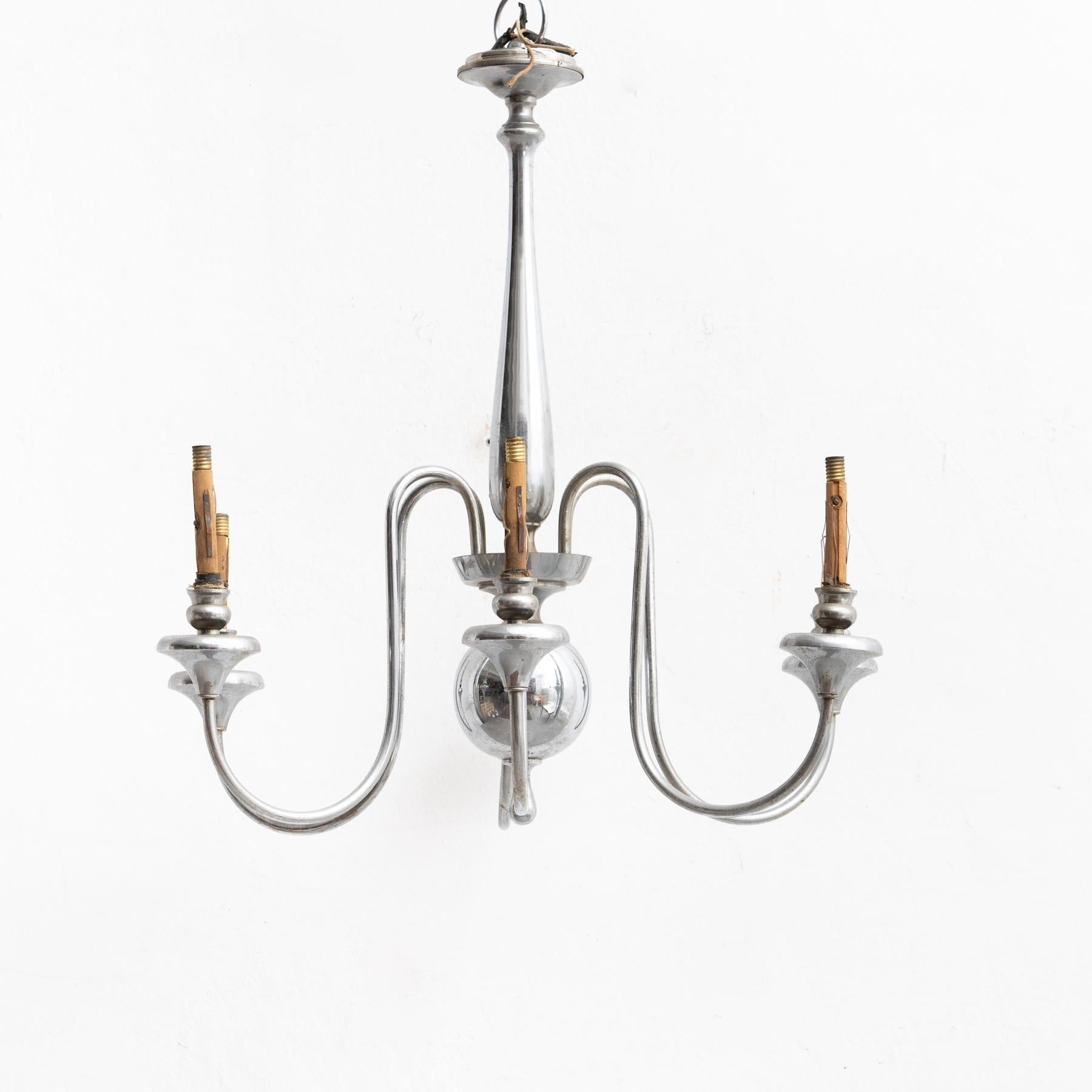 French vintage metal Art Deco hanging lamp.  By unknown manufacturer from France, circa 1930.  In original condition, with minor wear consistent with age and use, preserving a beautiful patina.  Materials: Metal.   Electricity not tested. Wired for