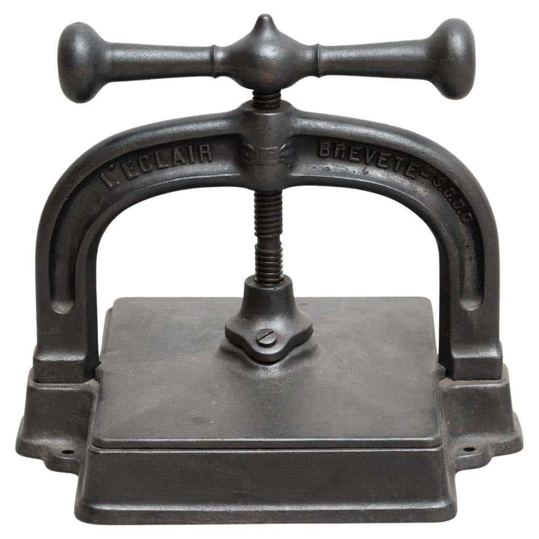 Vintage rustic rotating metal paper printing press tool.

By unknown manufacturer France circa 1900.

In original condition, with minor wear consistent with age and use, preserving a beautiful patina.

Materials:
Metal.
 