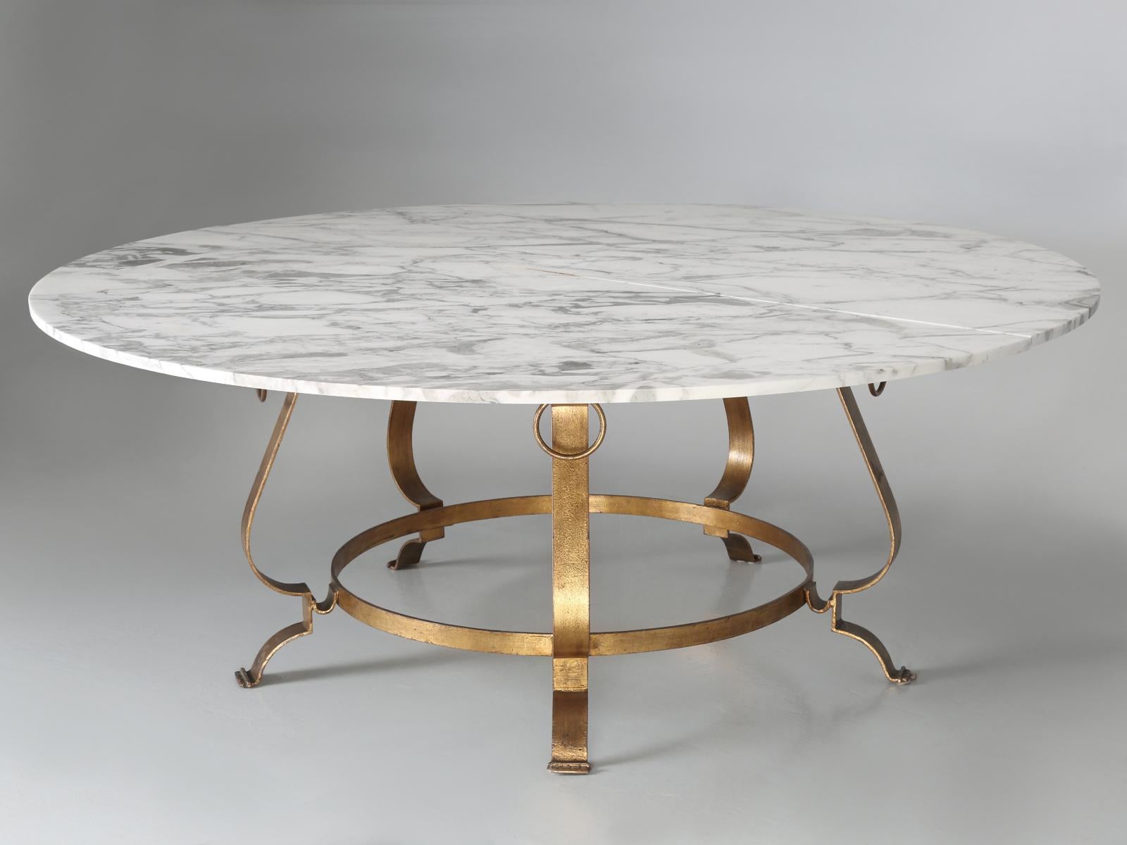 Vintage French Mid-Century Modern dining room table, with a spectacular honed Arabescato Carrara marble top imported from Italy. The table base is still in its original gilt finish and the marble has not been repaired and remains crack-free. The
