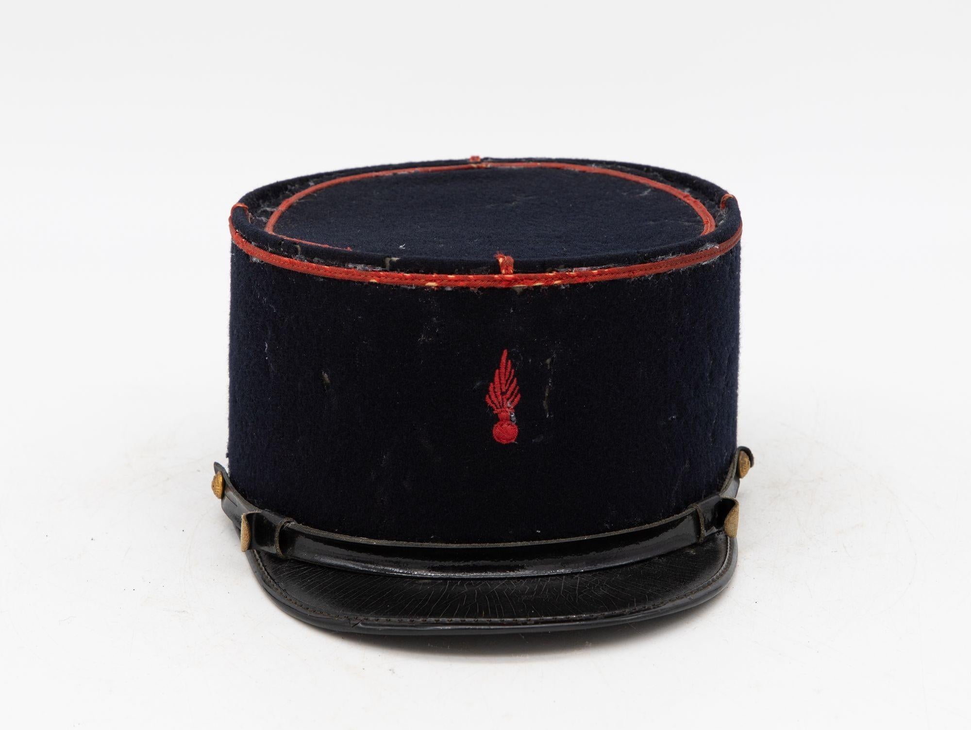 A rare French Military Academy Officer's hat or cap from the 1970s. These special and unique hats are part of the uniform of students studying to become officers in the French Military. This cap features a black leather brim on black felt with a red